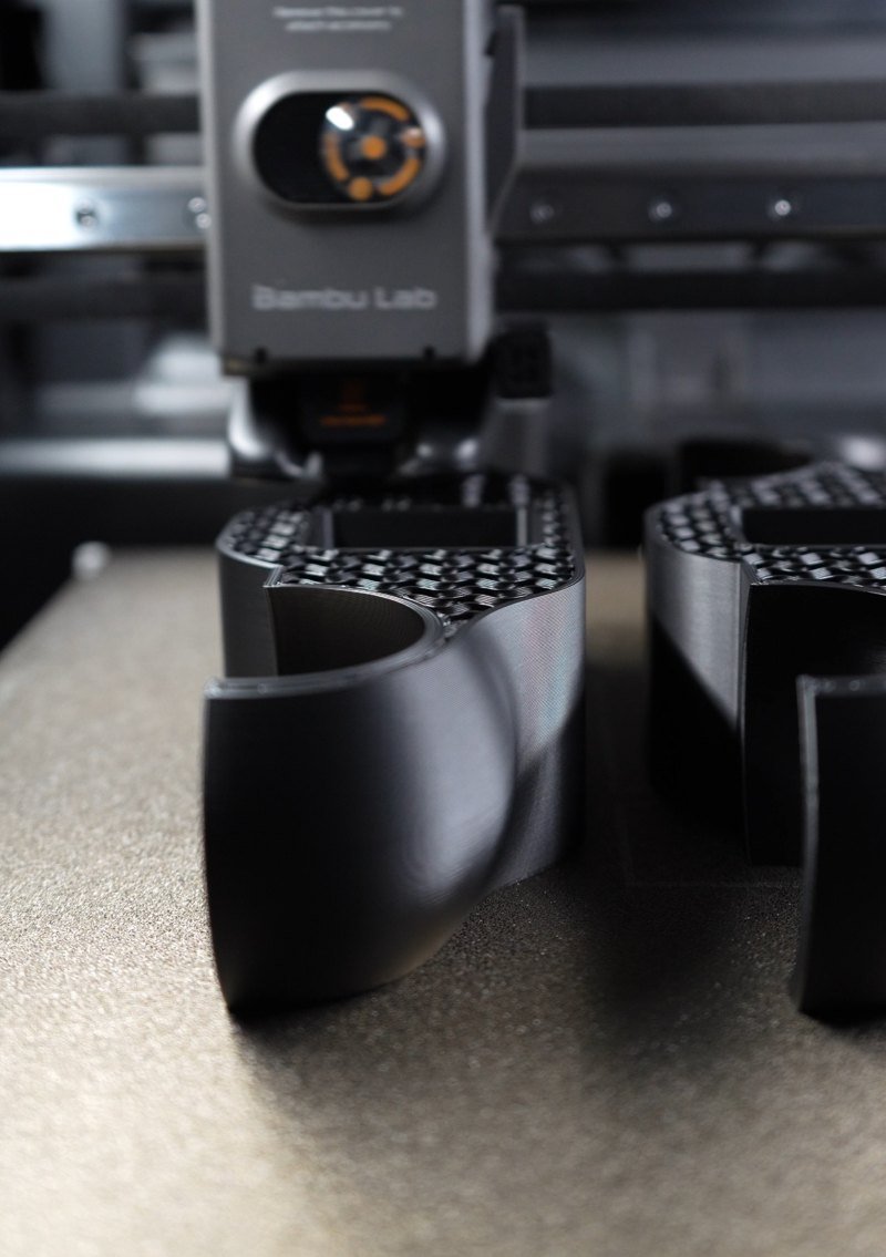Black PETG rocker feet printing on a Bambu Lab printer