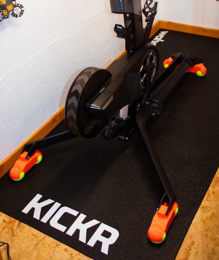 Wahoo KICKR BIKE PRO on orange rocker feet with tennis balls