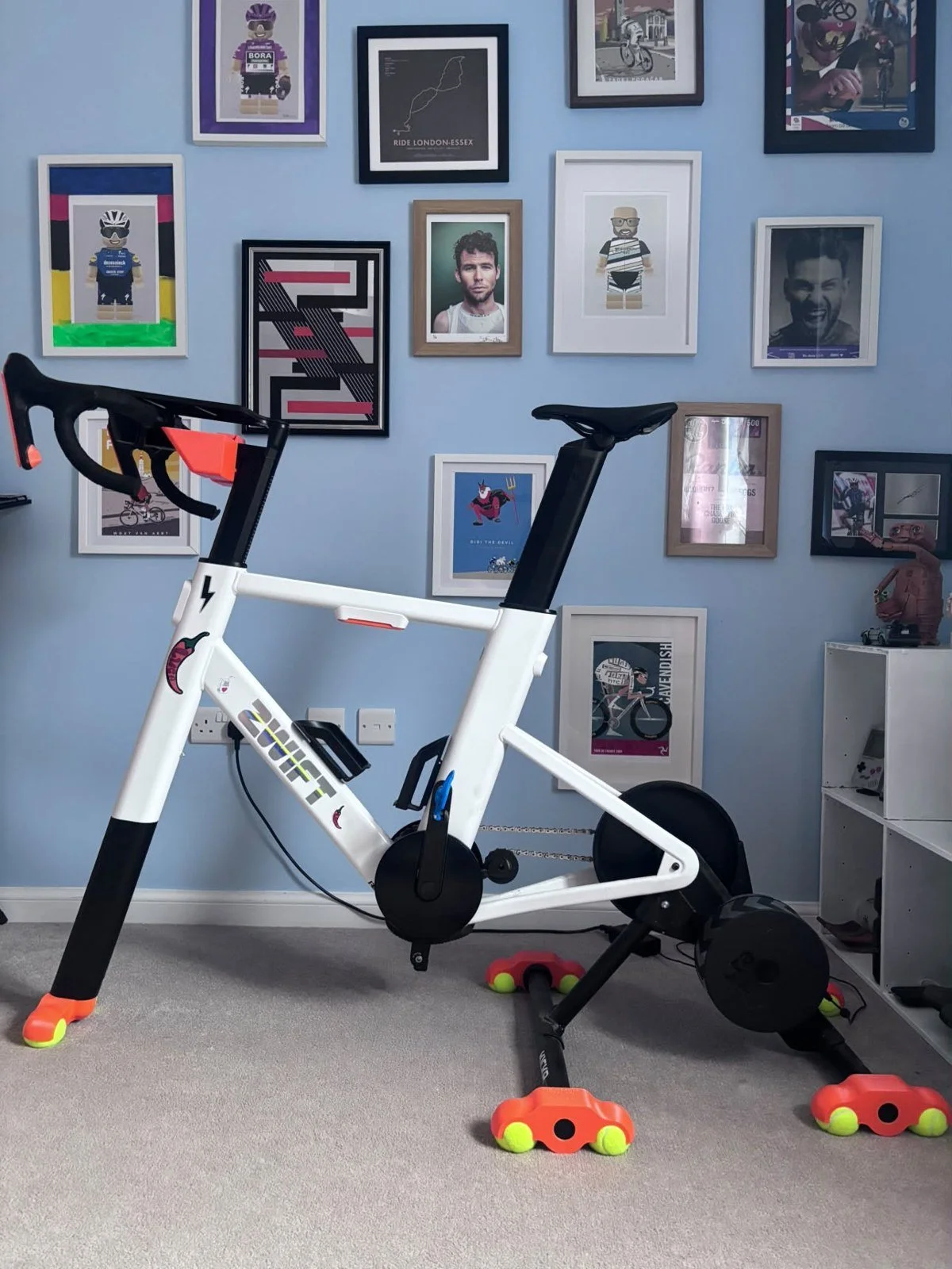 Zwift Ride on orange rocker feet and front foot in a rider's pain cave