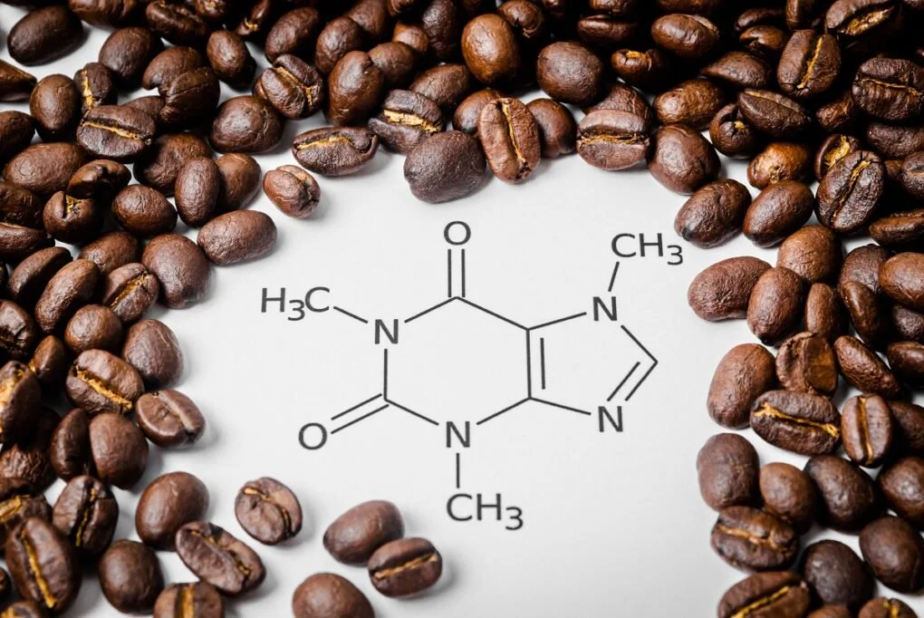 Coffee beans surrounding a chemical structure diagram of caffeine on a white background.