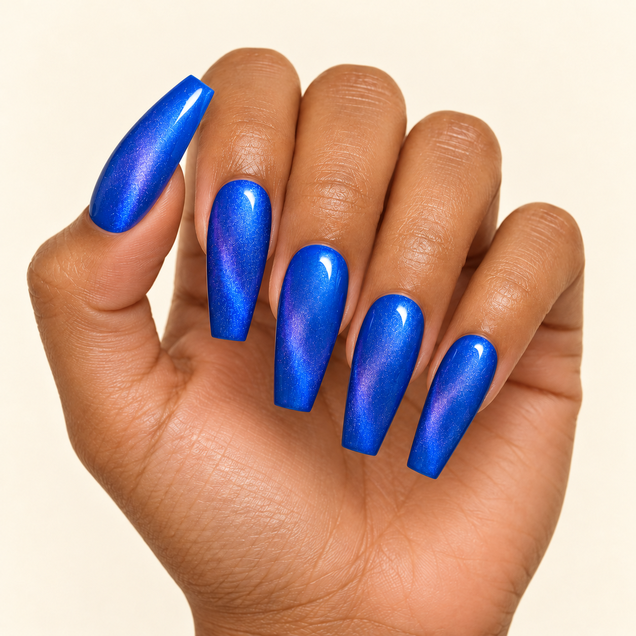 Curled hand with glossy cobalt coffin nails-2.png