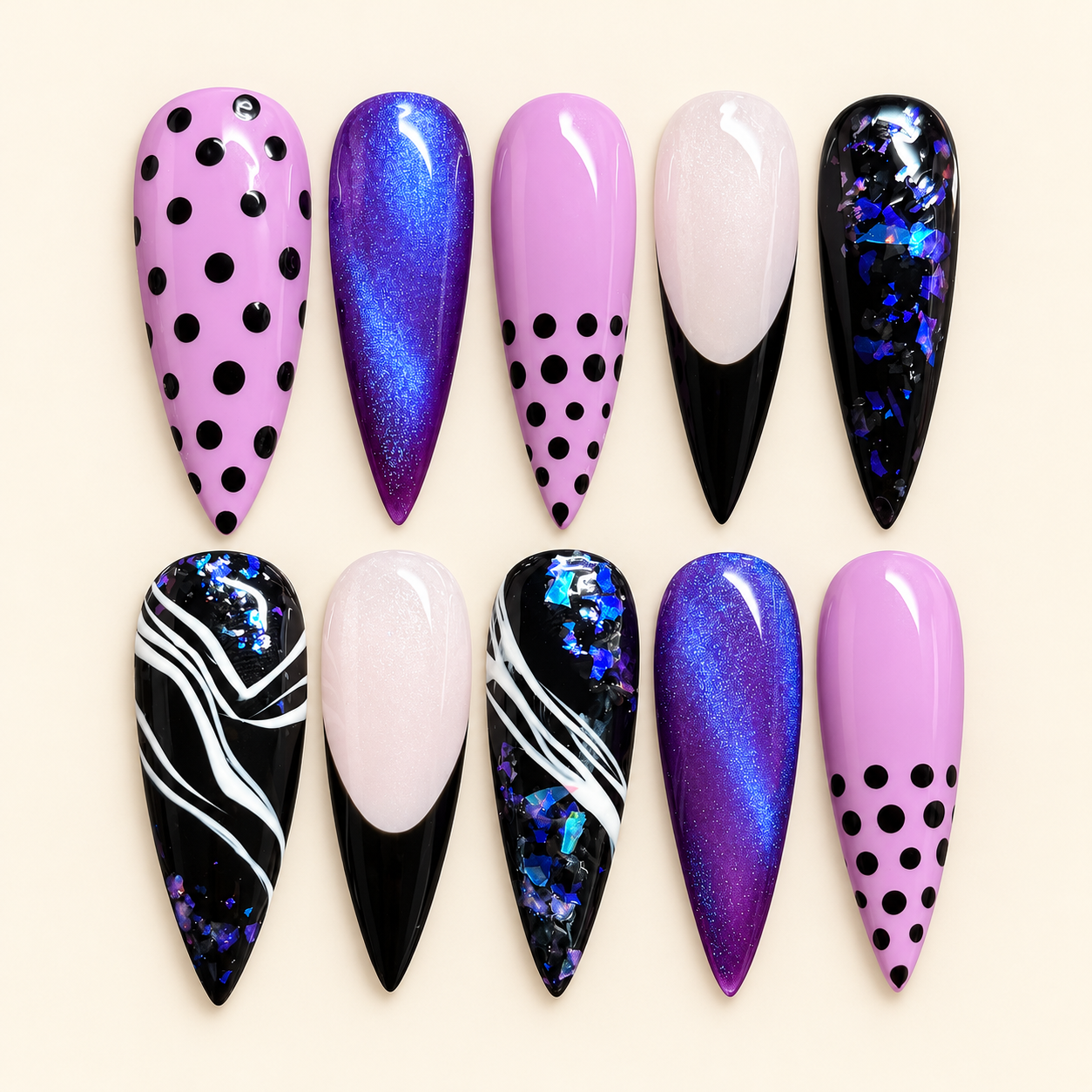 Luxury stiletto nail set flat lay.png