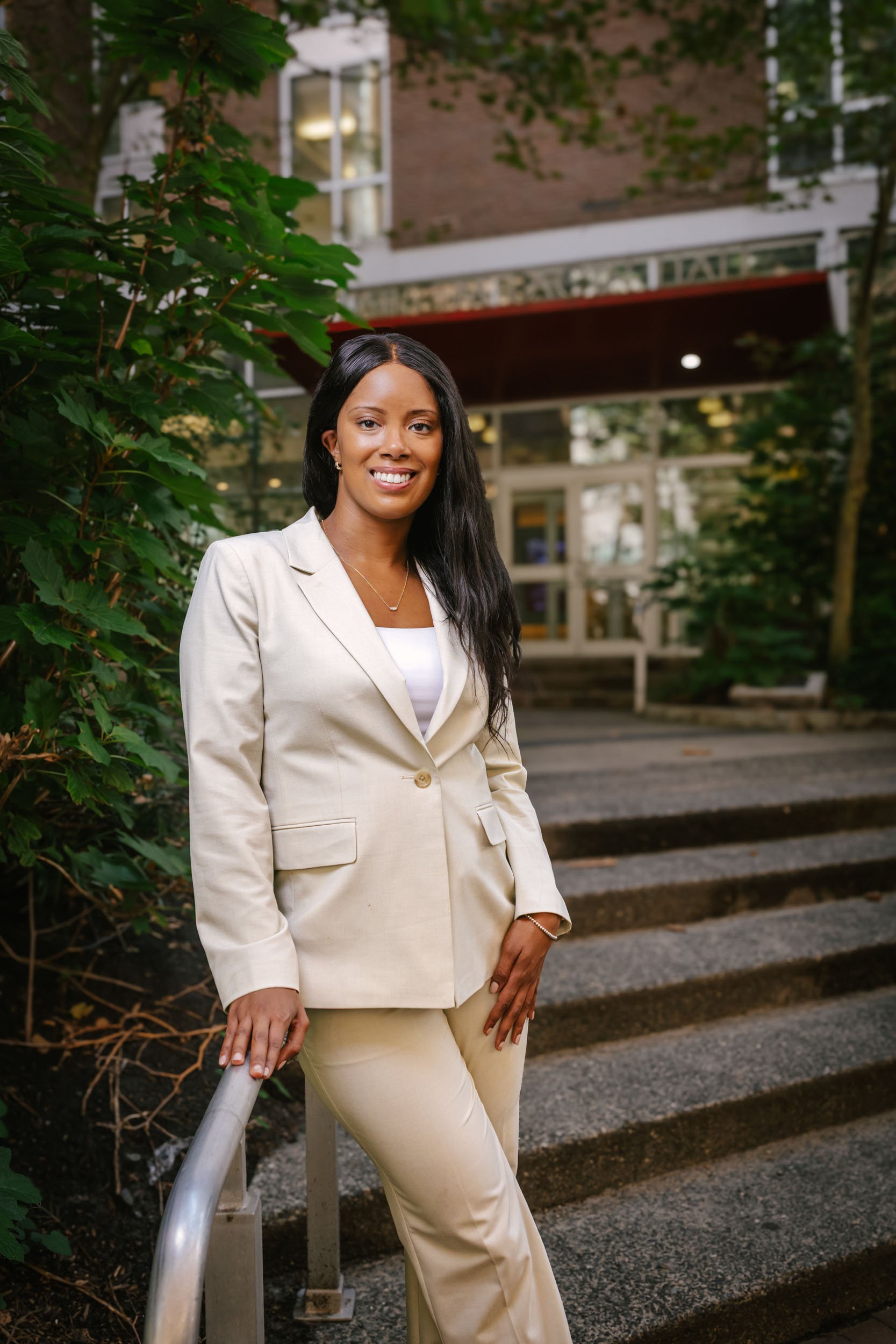 Dr. Justinna Dixon, nurse scientist and health policy researcher, standing outside Claire M. Fagin Hall at the University of Pennsylvania