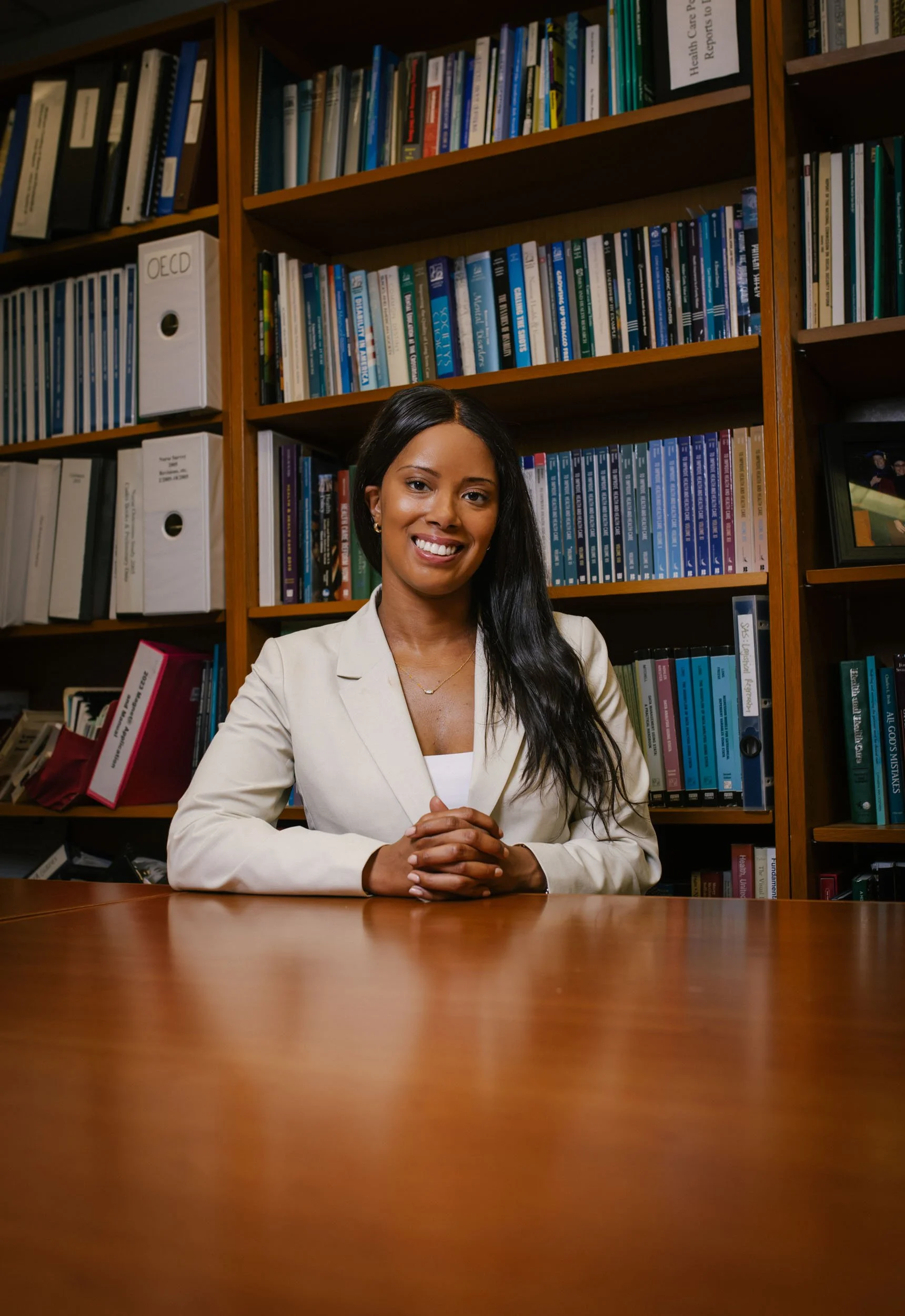 Dr. Justinna Dixon, psychiatric mental health expert and nurse scientist, seated in a research library