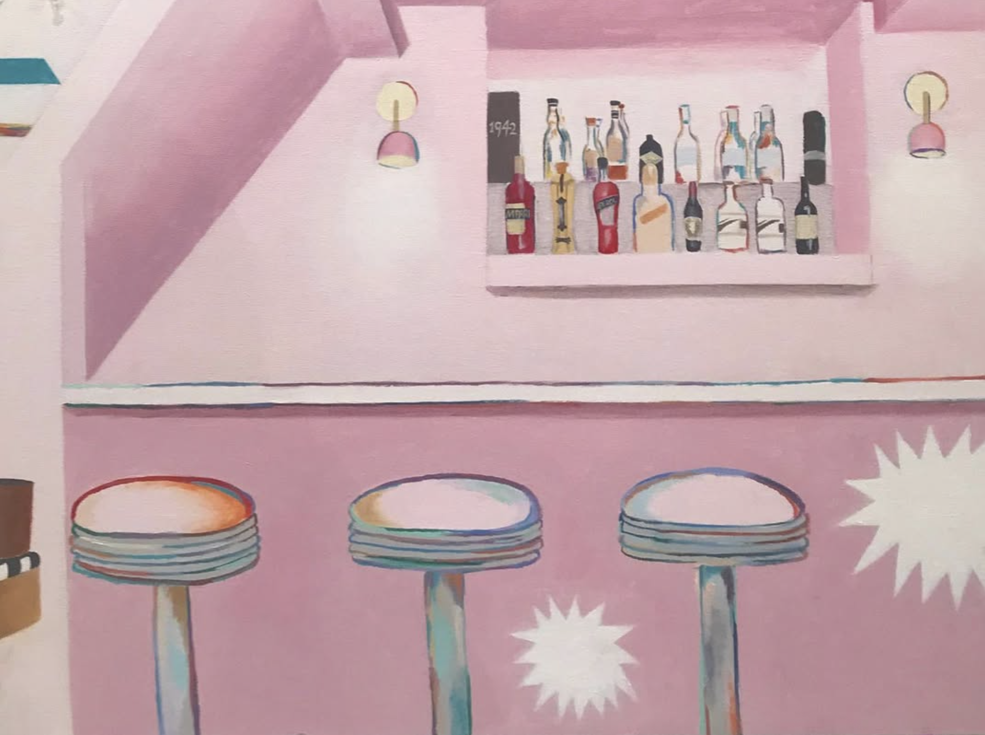 three stools sit flush against a bar, with a mirrored niche above it displaying various liquors