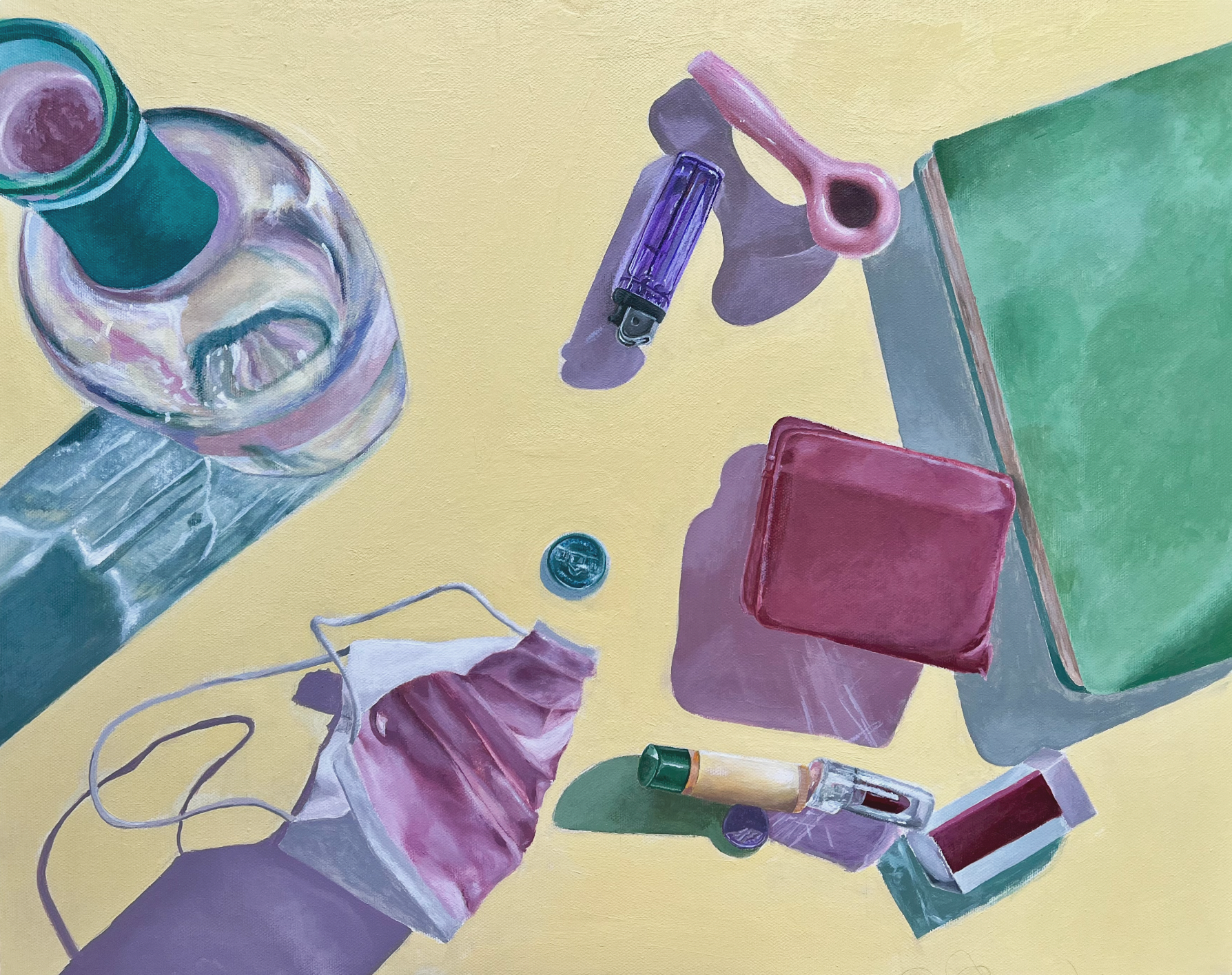flatlay of a pale yellow surface with objects scattered throughout: a wine bottle, lighter, chapstick, eraser, wallet, journal, glass bowl, coin, and mask.