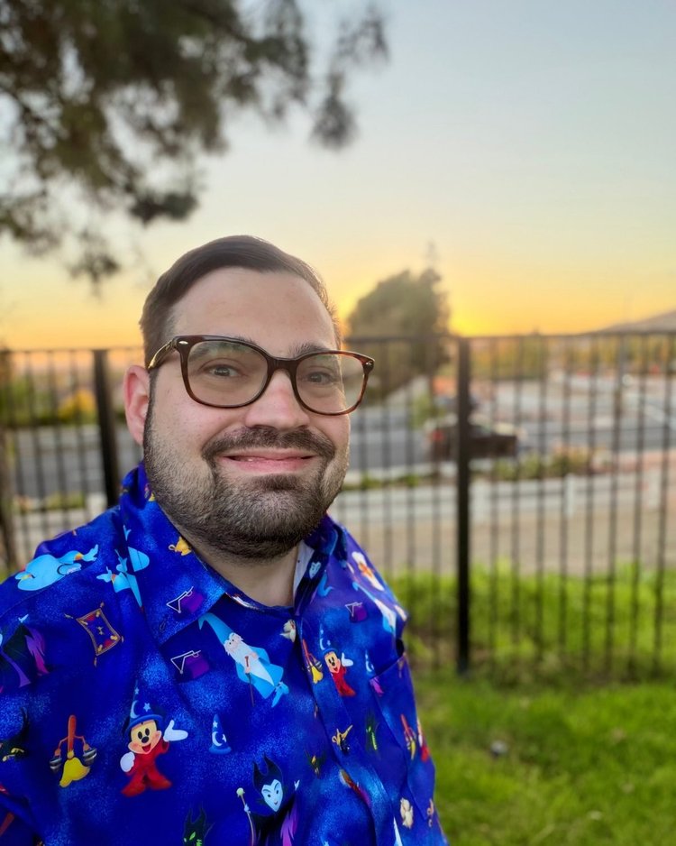 Josh smiling outdoors at sunset
