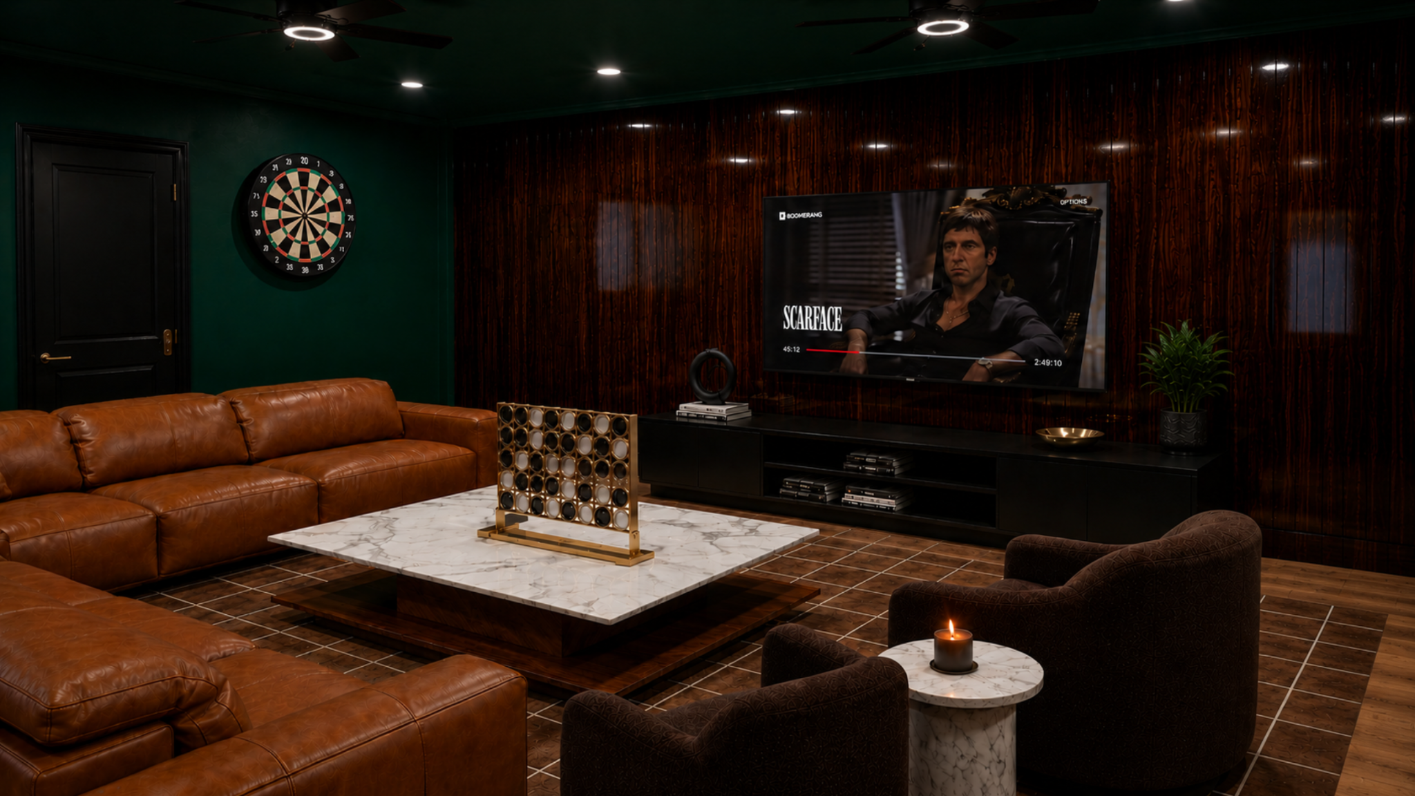 A cozy basement living room with green and wood-paneled walls, a dartboard, a leather sectional sofa, a marble coffee table, a flat-screen TV displaying the movie Scarface, a potted plant, and a candle on a small marble side table.