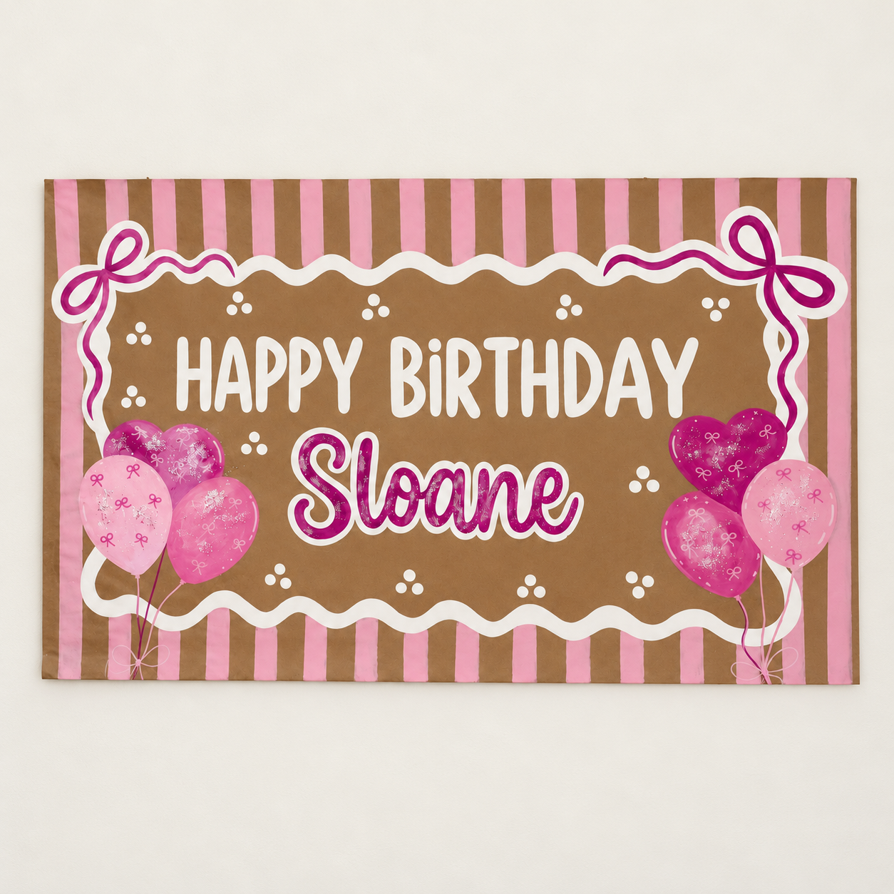 Sloane birthday banner on cream wall-2.png