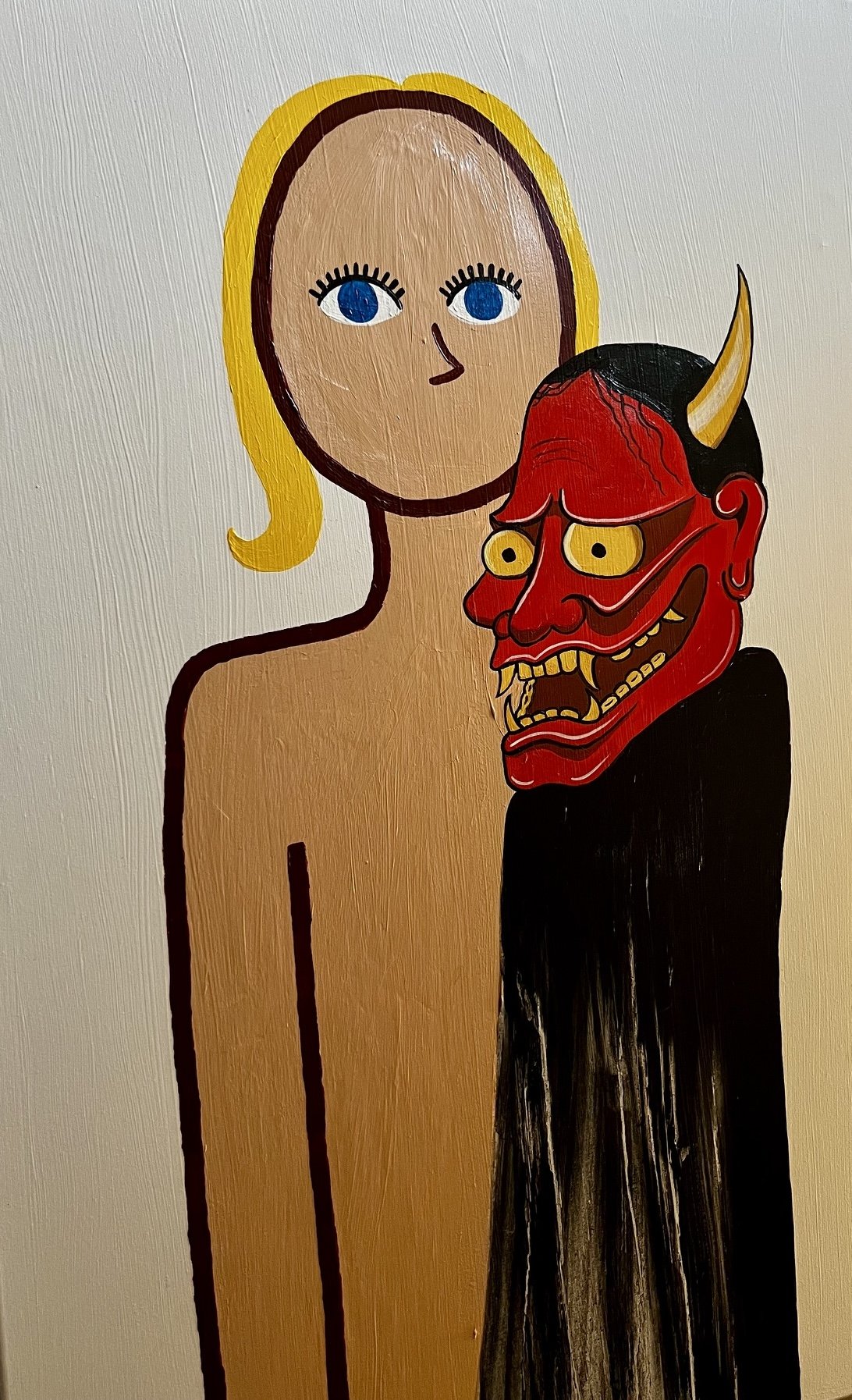 A painting of a nude woman with blonde hair, blue eyes, and black eyelashes, standing next to a red and black traditional Japanese Hannya mask with horns and sharp teeth.