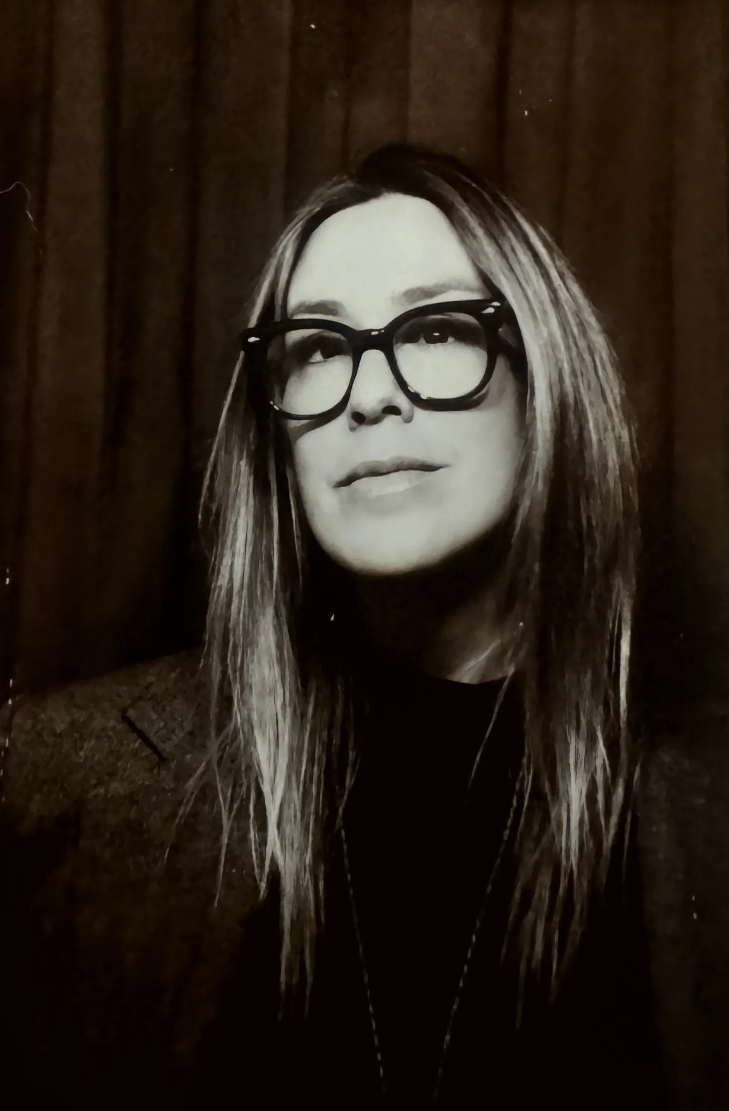 Black-and-white portrait of Crystal Wooden, Los Angeles-based Creative & Brand Director, wearing her signature glasses.