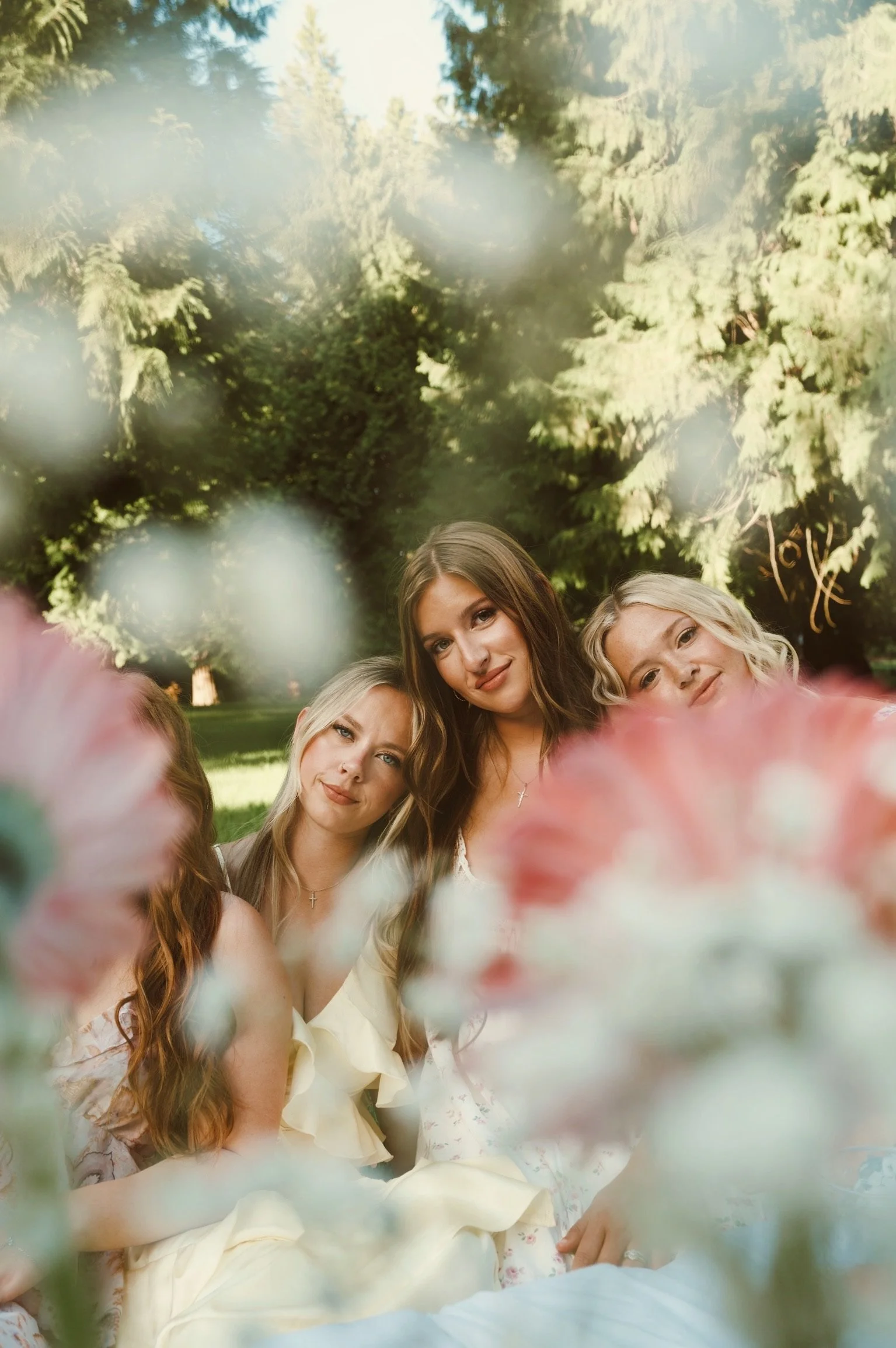 Two women surrounded by flowers during Caitlyn Deming’s garden-inspired branding photoshoot.