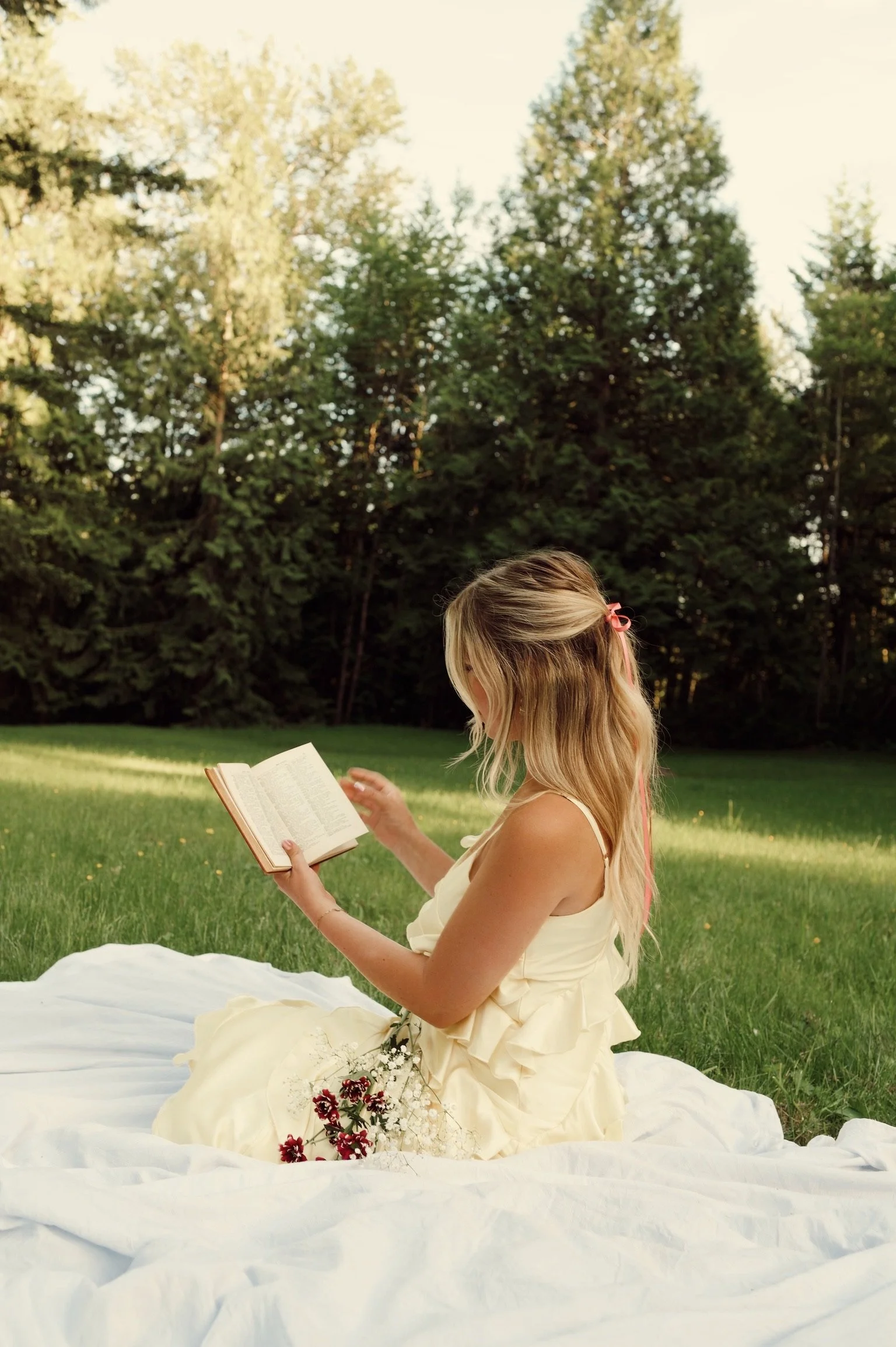 Woman relaxing on the grass with a parasol during Caitlyn Deming’s garden-inspired branding photoshoot.