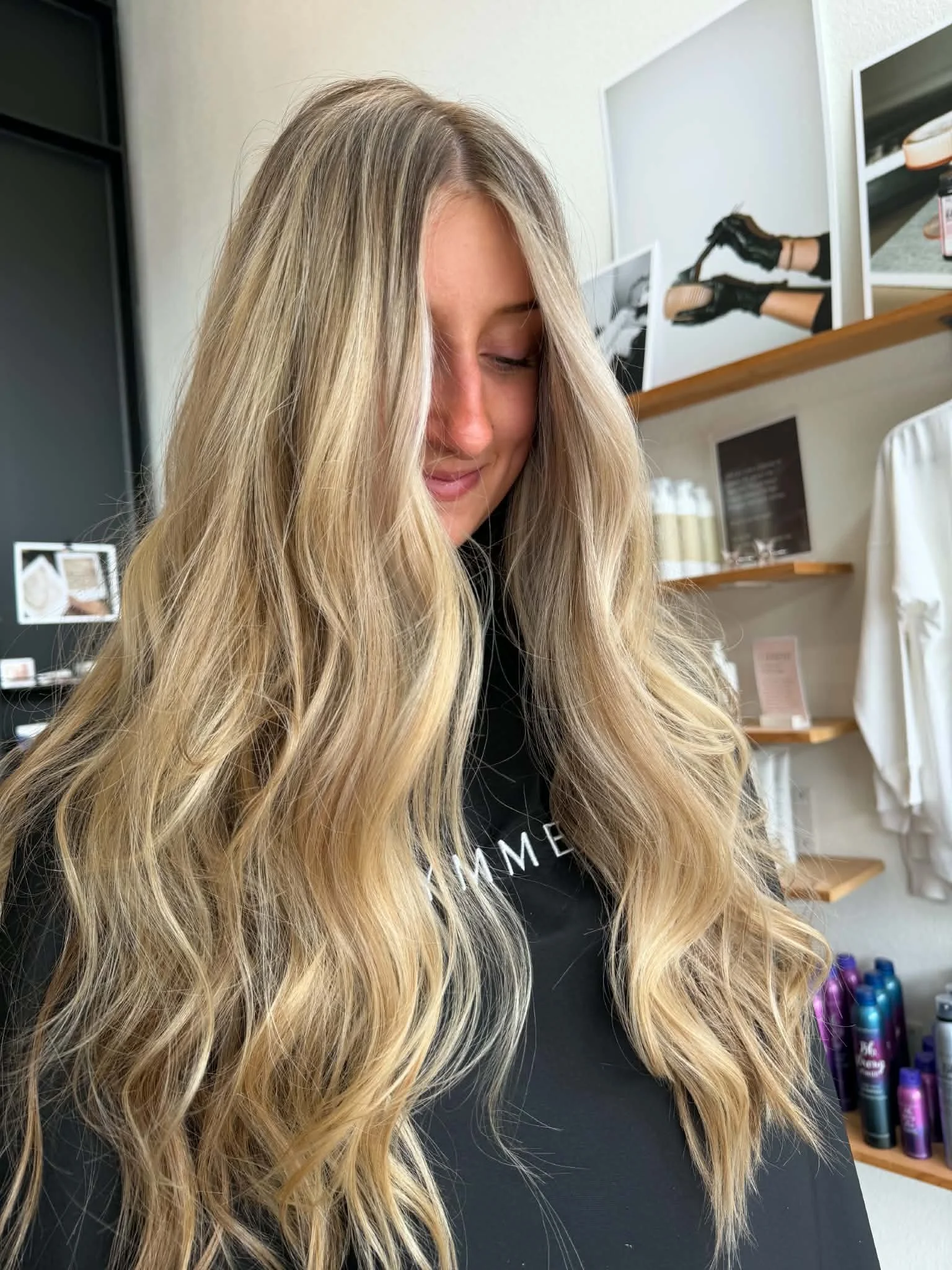 Long blonde hair with dimensional highlights and soft, loose waves by Caitlyn Deming.