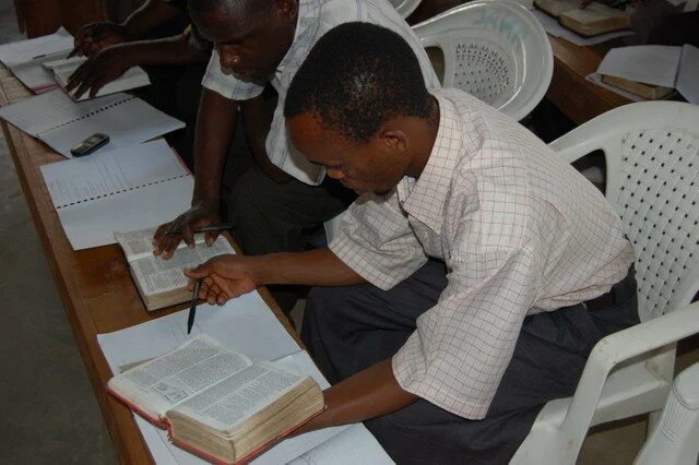 Pastors reading and taking notes during biblical training