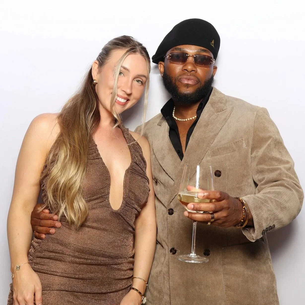 Couple posing at photo booth rented for event