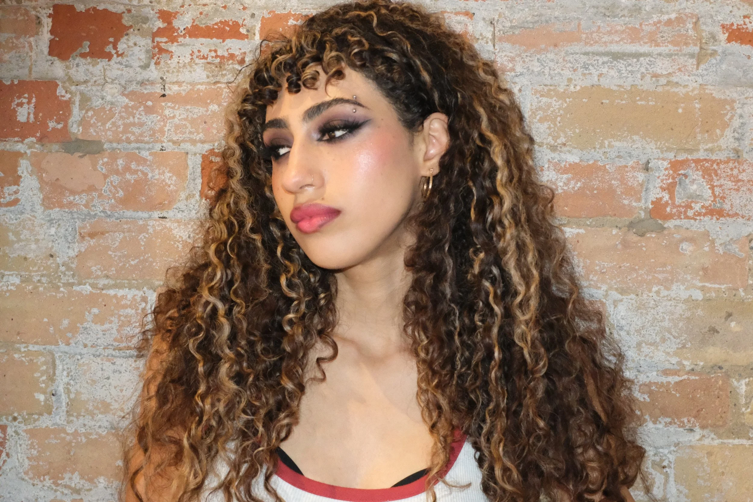 Punk-inspired purple smoky eye makeup with bold, edgy glam