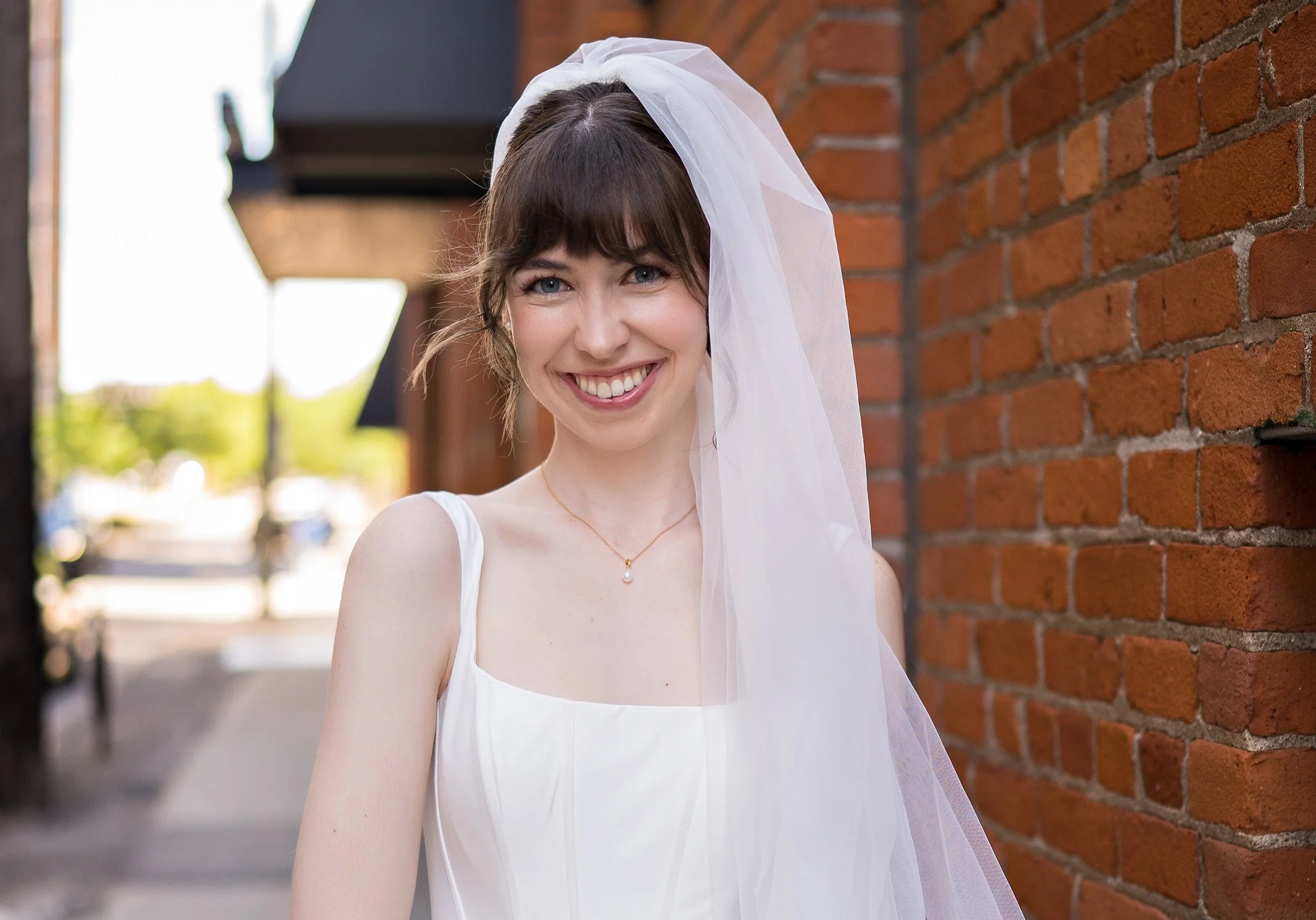 Polished bridal updo and natural, glowing makeup