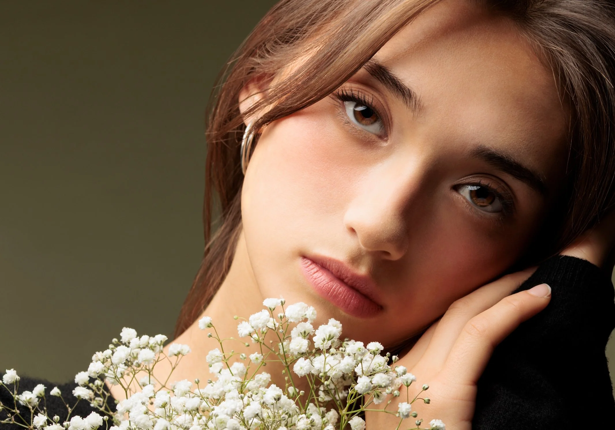 Feminine, soft pink makeup accentuating the model’s features.