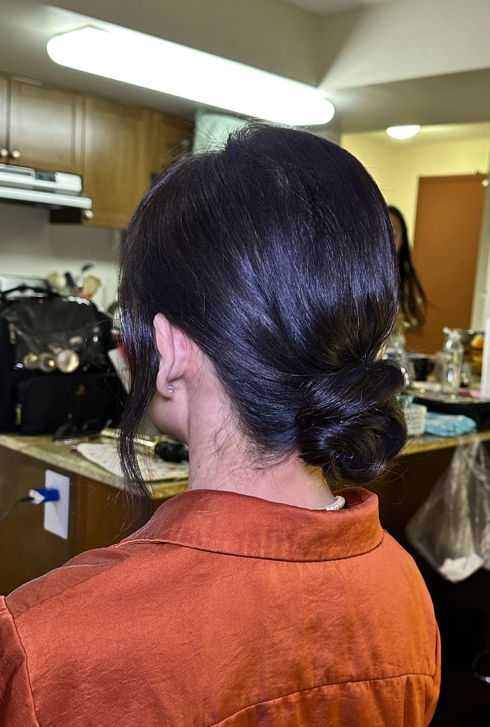 low bun updo for mother of bride with fine hair