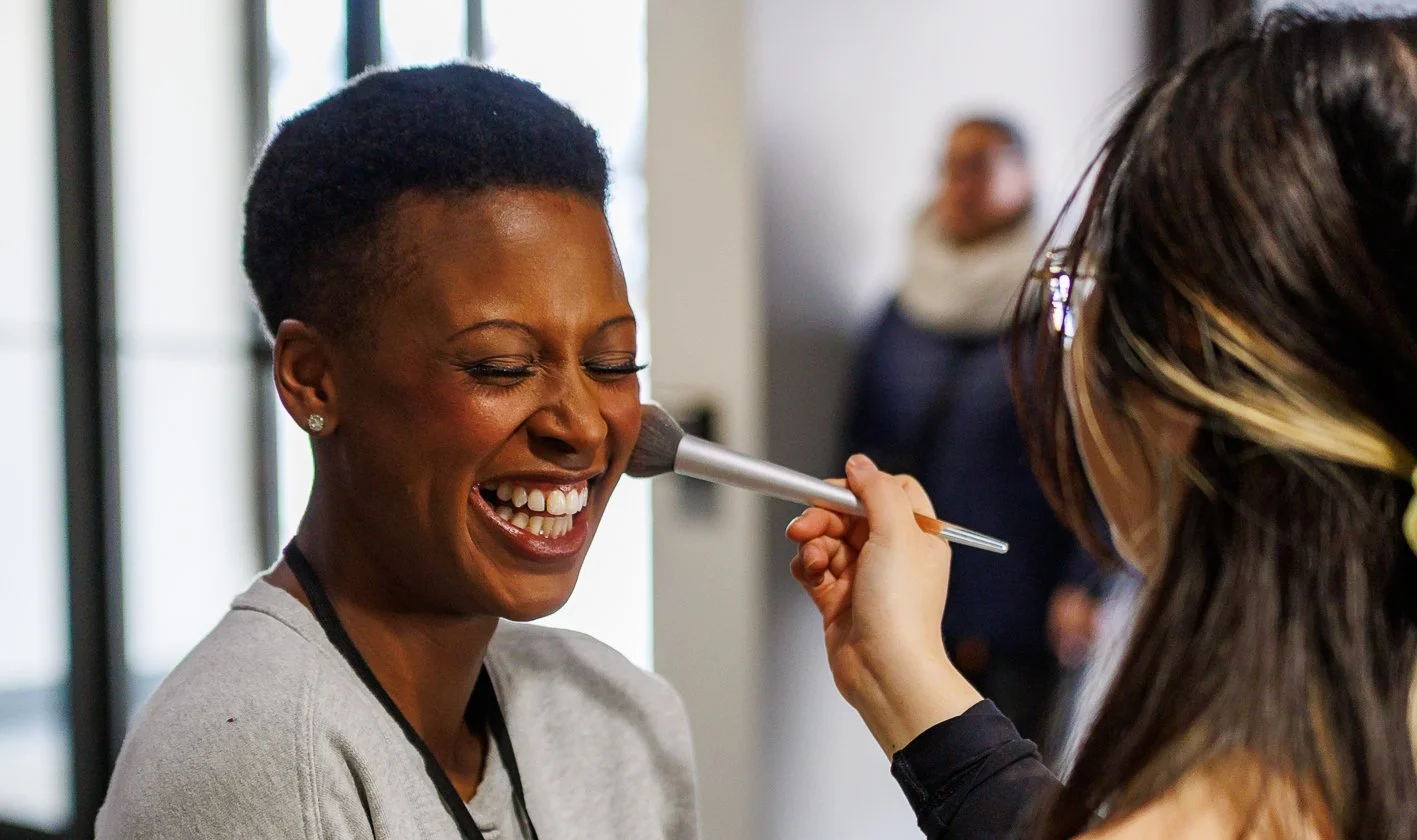 Alanna and model sharing a laugh, as she applies natural bridal makeup.