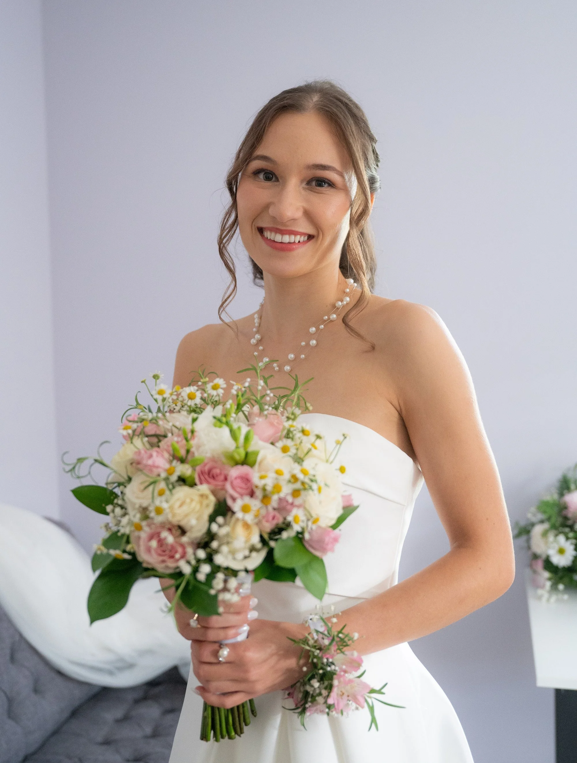 Bride smiling in natural bridal makeup that feels beautifully her.