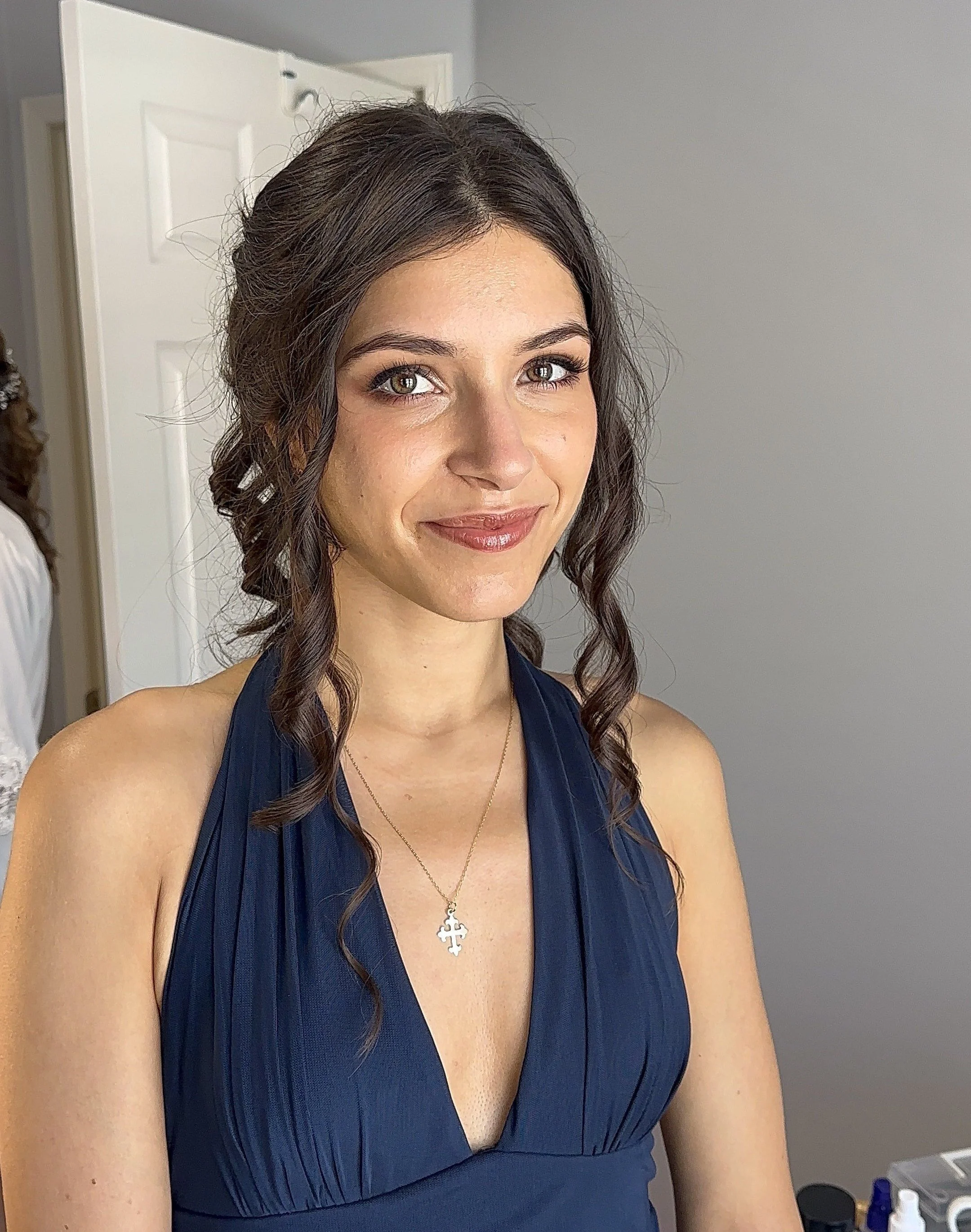 Bridesmaid wearing soft glam makeup with bold eye makeup that enhances her natural eye shape.
