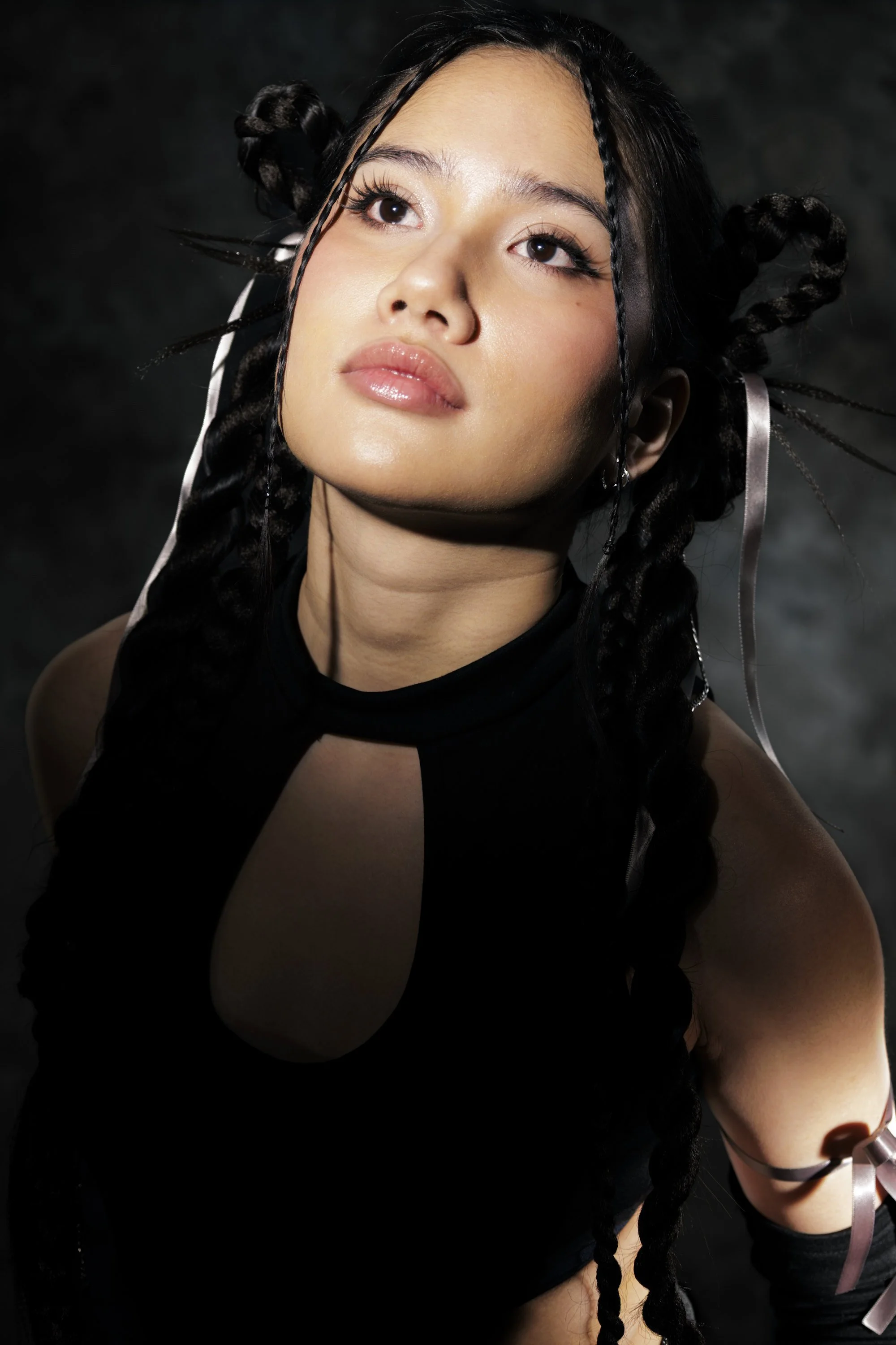 Y2K glam makeup with long, spiky lashes and editorial braided hairstyling by Toronto makeup artist Alanna Tran.