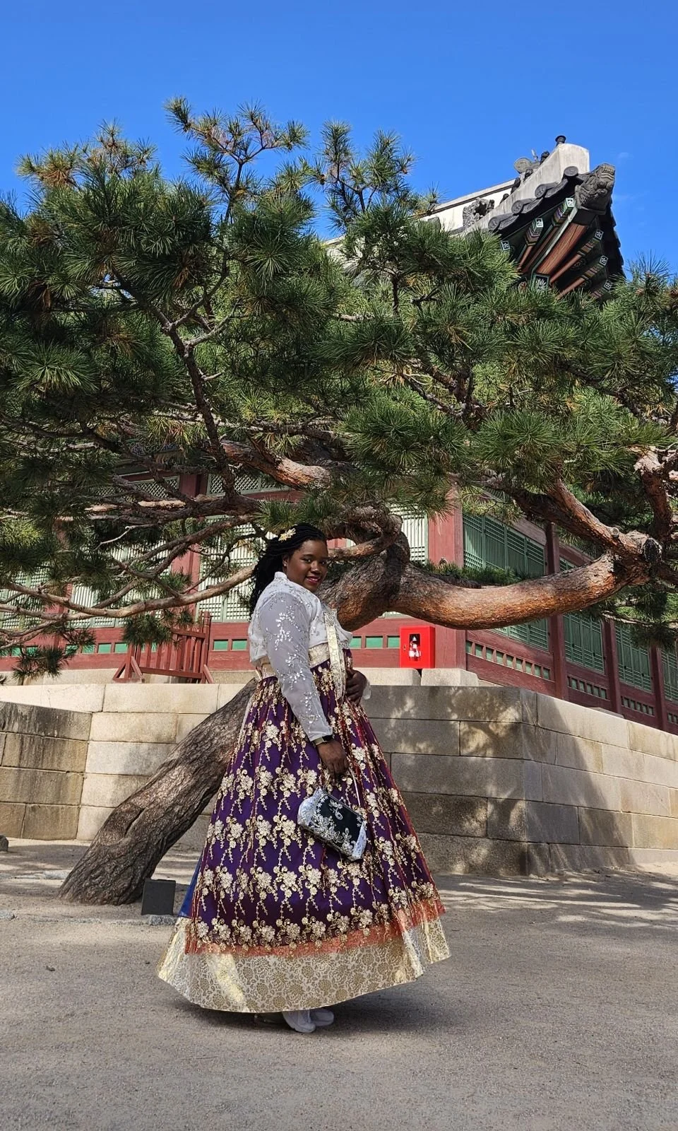 Keena posing in front of old tree on palace grounds