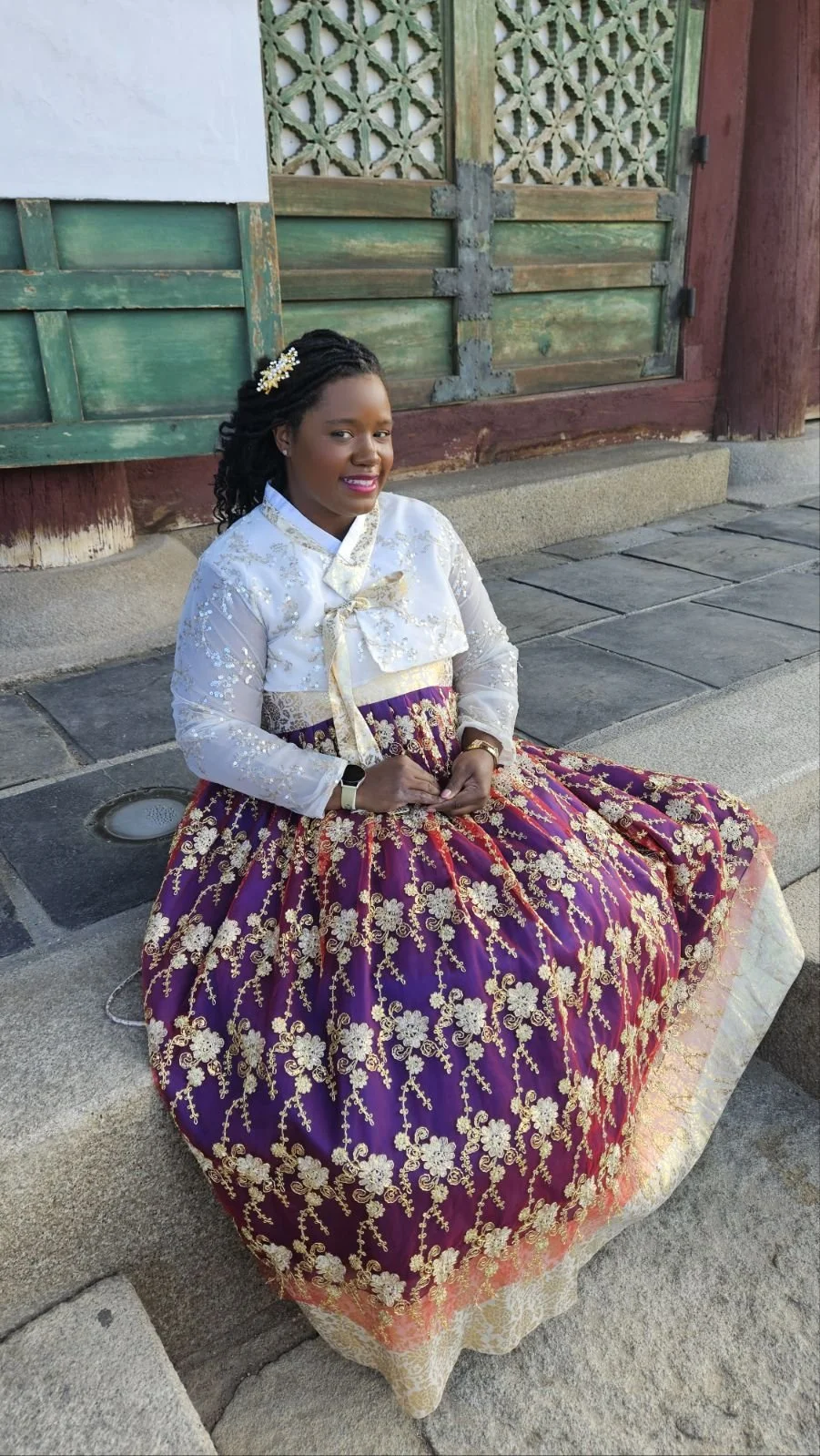 Keena sitting in palace grounds in Seoul