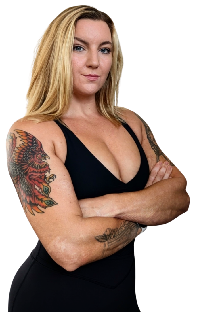 Rachel Huncke has blonde hair, muscular arms with tattoos, wearing a black sleeveless top and black pants, standing with her arms crossed.