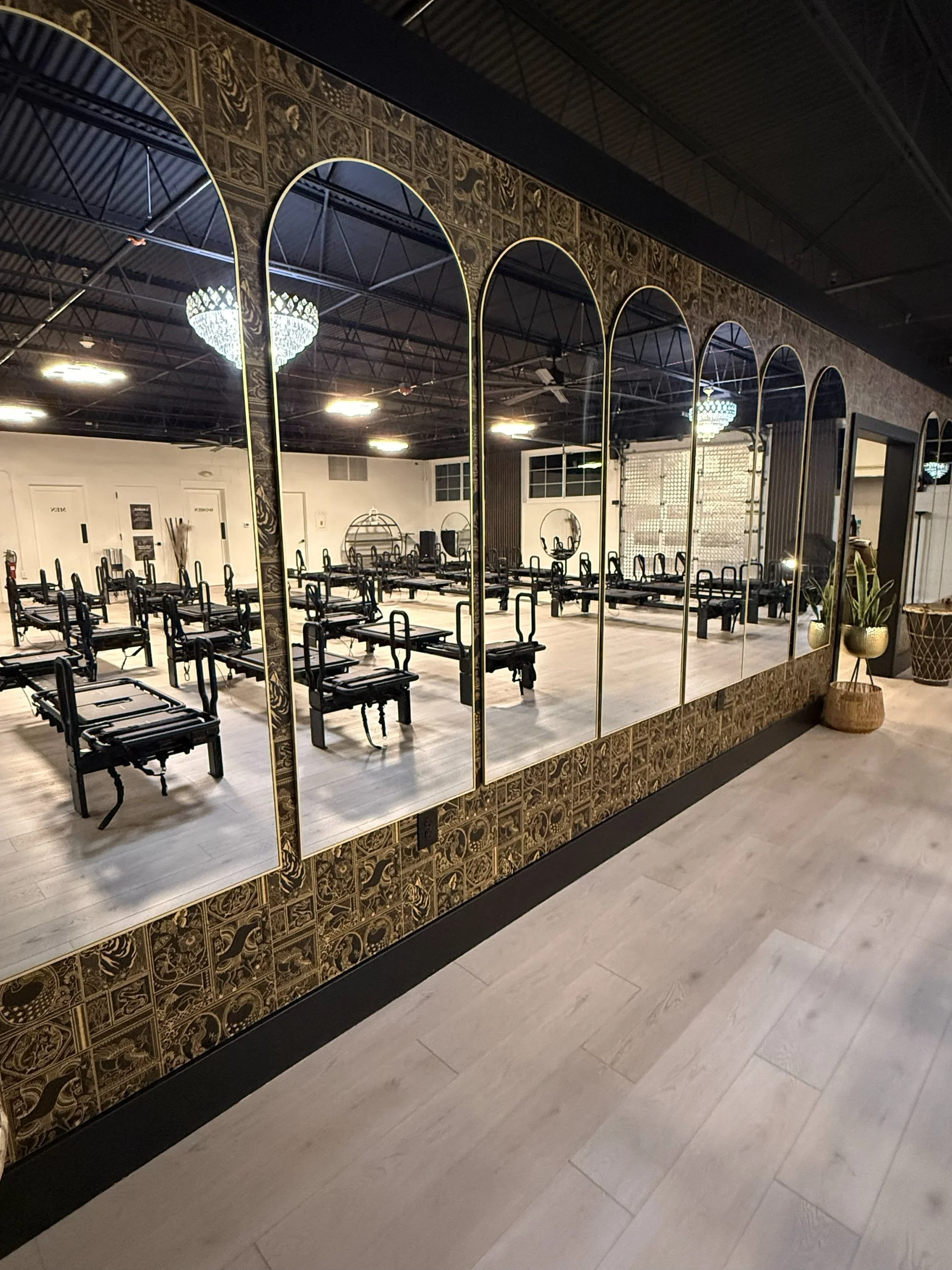 Venom Lagree Warrenville studio decorated with wall paper reflect rows of Lagree machines