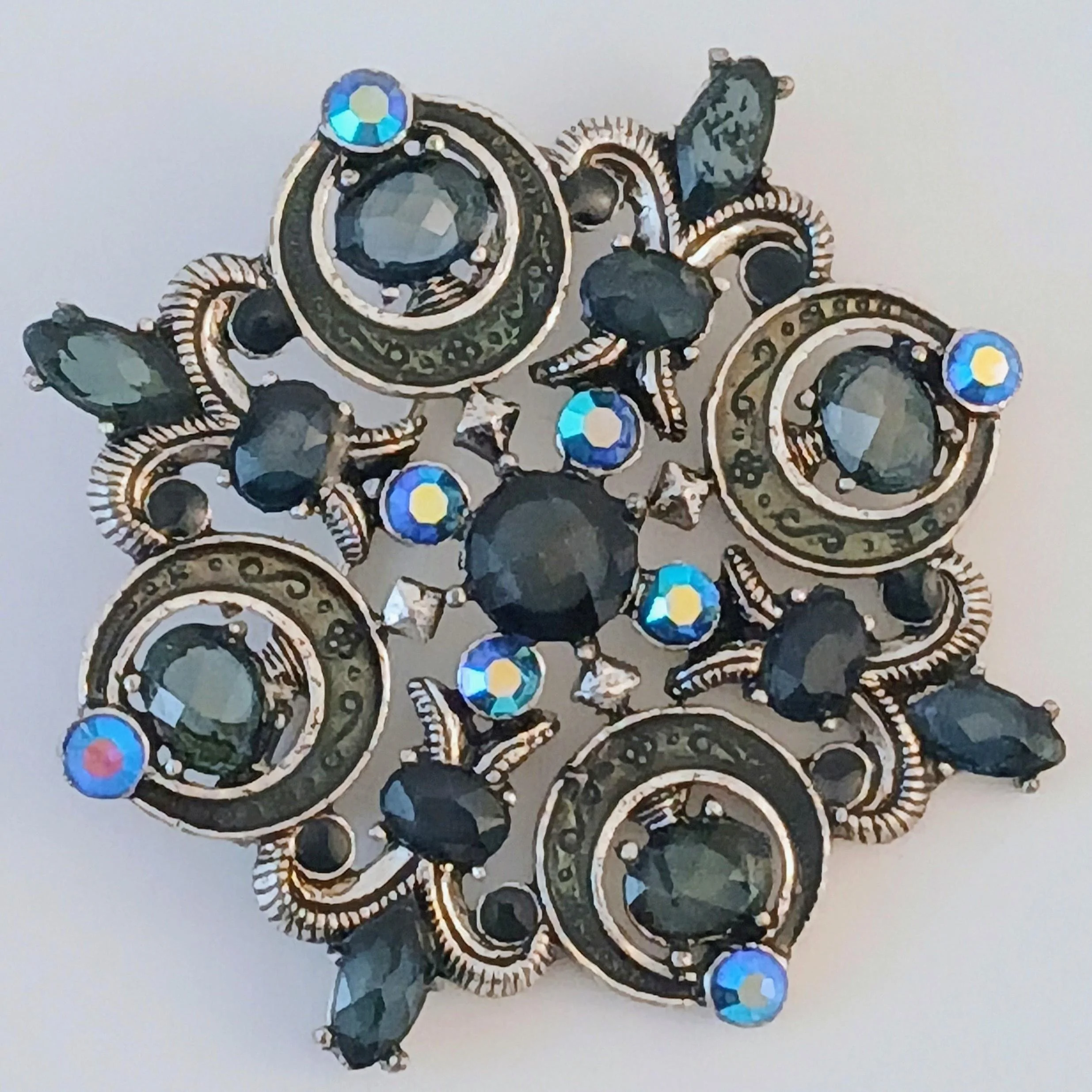 Beautiful vintage floral brooch dating from 1946 to 1958 crafted of bone china and measuring 2" long x 1.25" wide.  Maker: Crown China Crafts Mill St. Stoke, England  The delicate bouquet of hand-pain