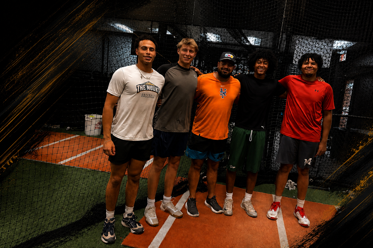 Group of five young men standing together on an indoor tennis court, smiling, with a net behind them.