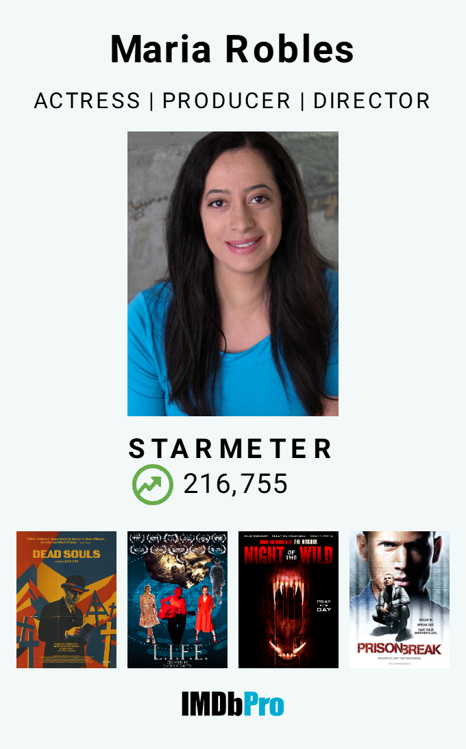 Profile picture of Maria Robles, actress, producer, director, wearing a blue top, with dark hair, in front of a gray background.