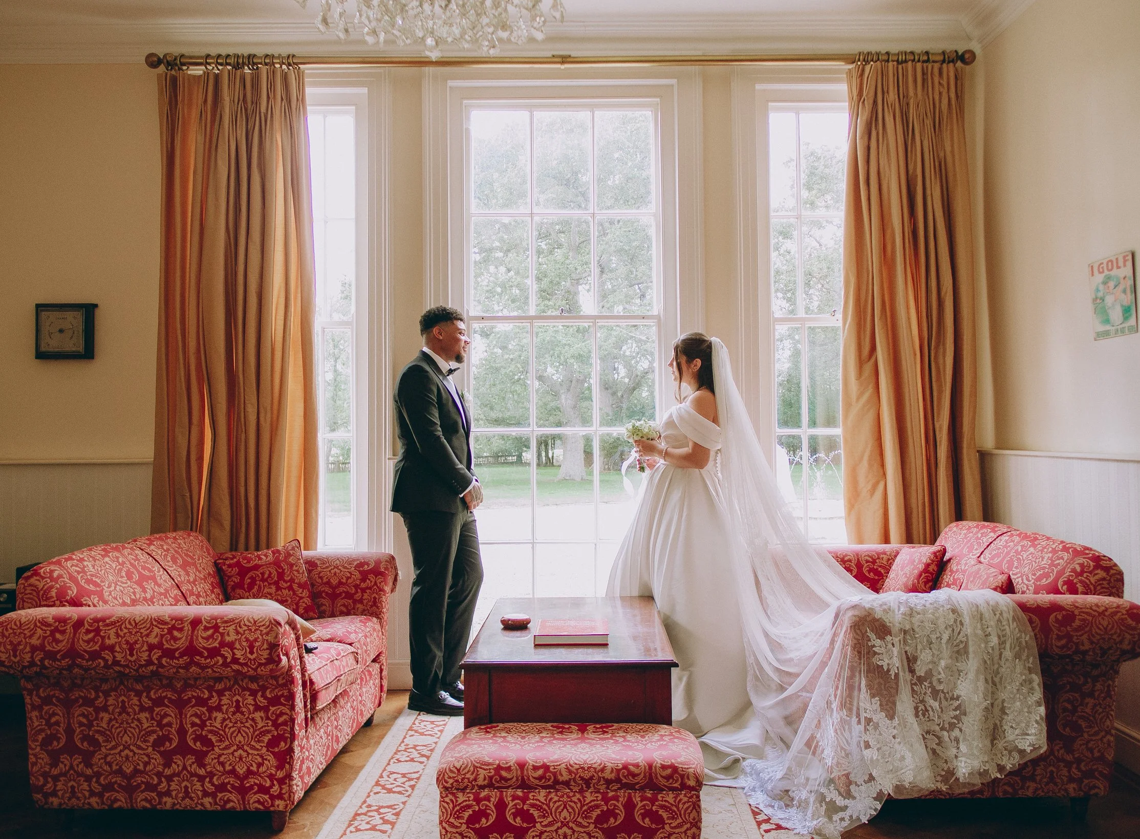 Bride and groom holding hands on the manicured lawns during a luxury estate wedding at Woodhall Spa Manor in Lincolnshire.
