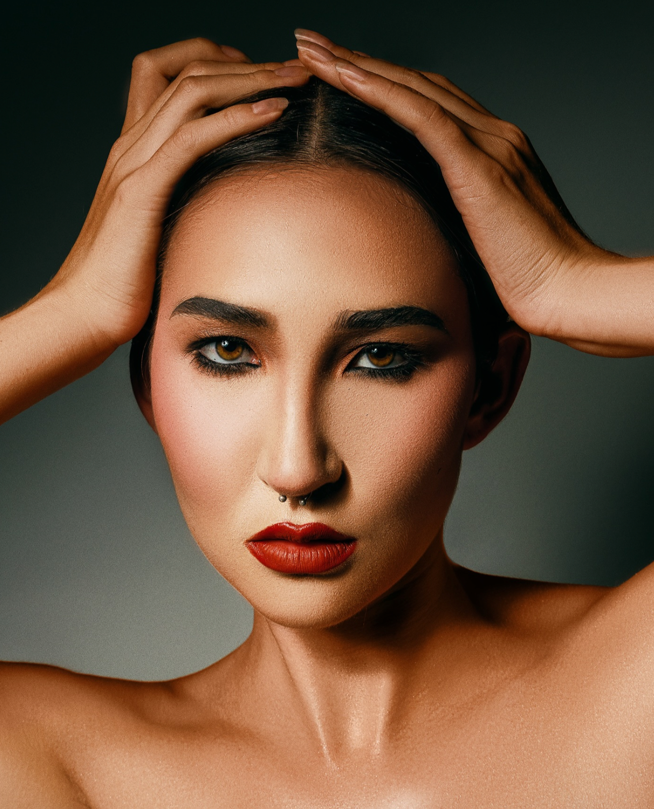 Close-up beauty portrait highlighting hair movement and studio rim lighting for a luxury skin care brand in London.