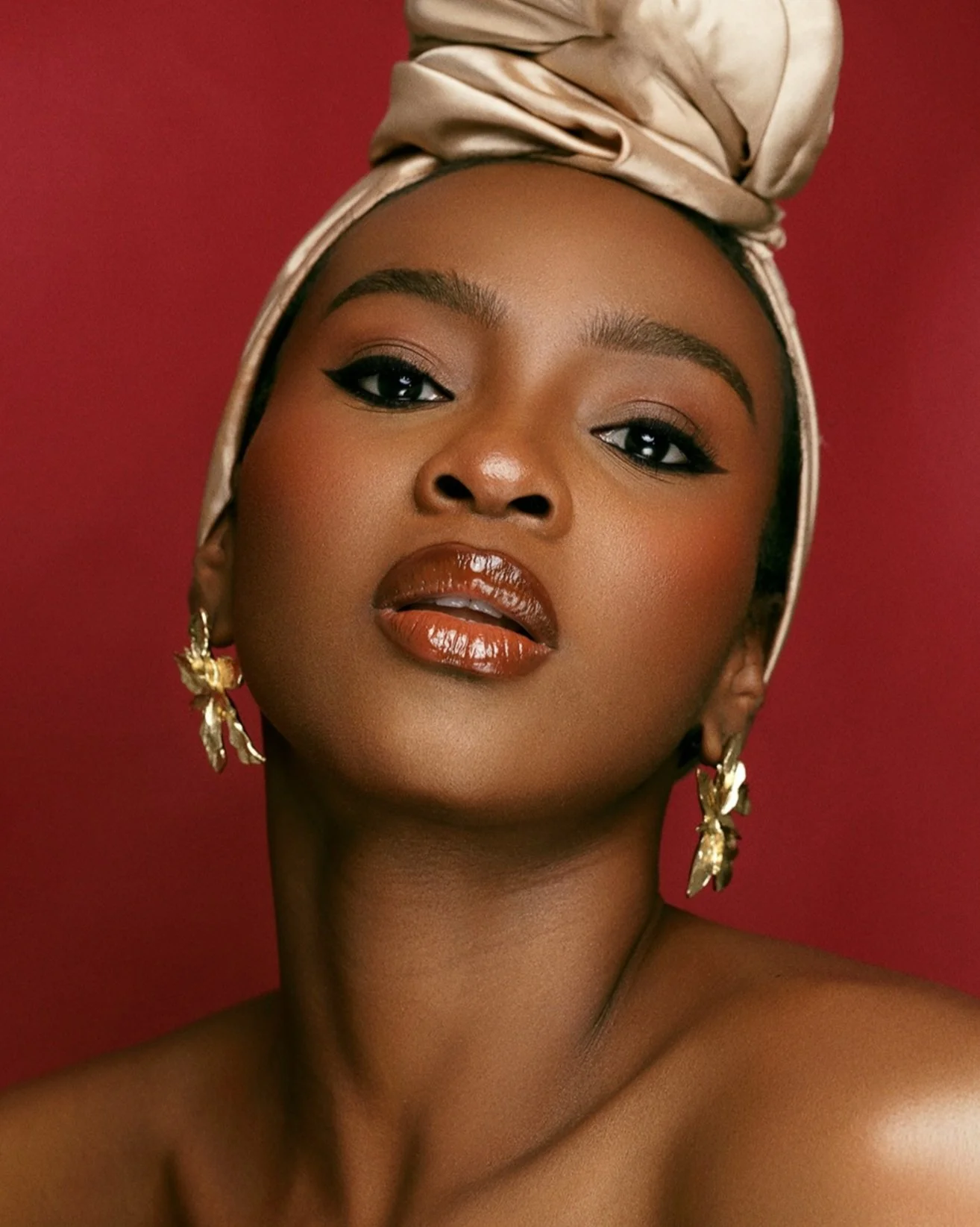 Fashion model posed in bold editorial makeup with structured studio lighting for a brand lookbook in Birmingham.