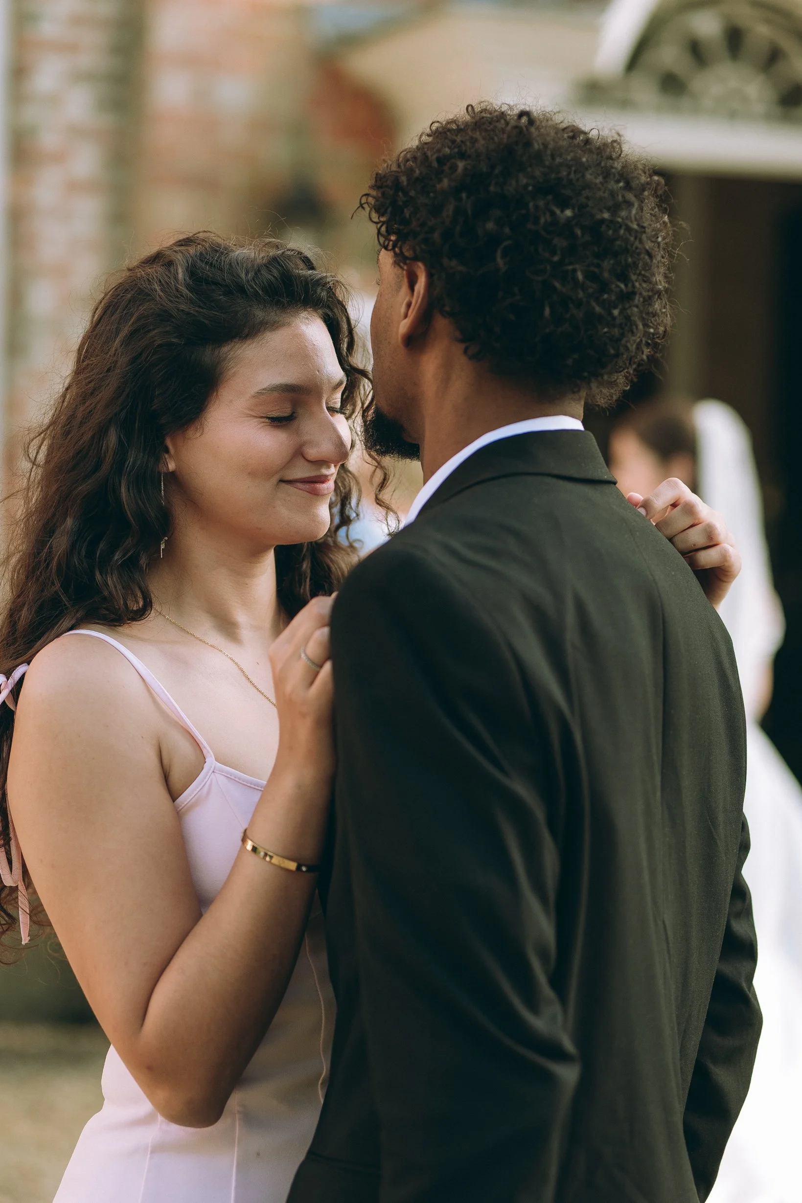 Bride and groom walking along historic red-brick canals and iron viaducts during a Manchester city center wedding.