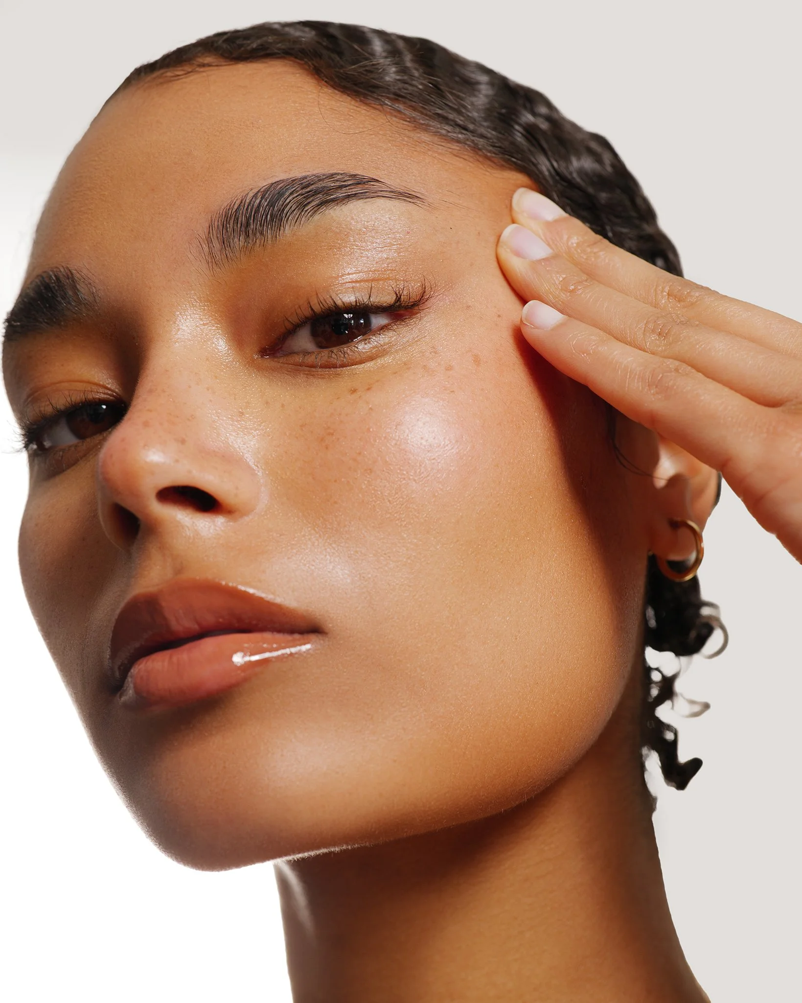 Close-up studio beauty portrait featuring vibrant lip makeup and flawless skin retouching in a london photography studio.