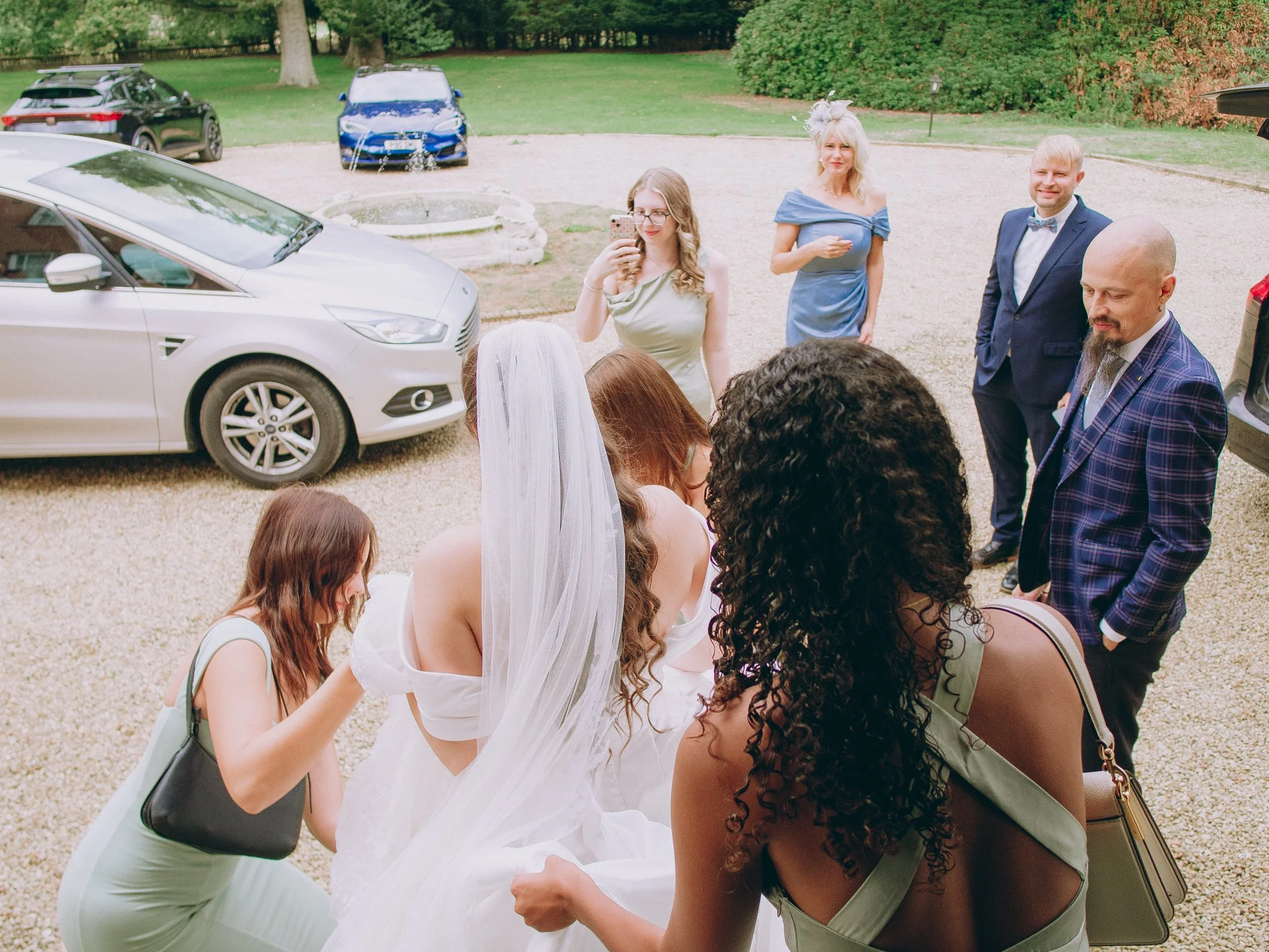 Bride and groom holding hands on the manicured lawns during a luxury estate wedding at Woodhall Spa Manor in Lincolnshire.