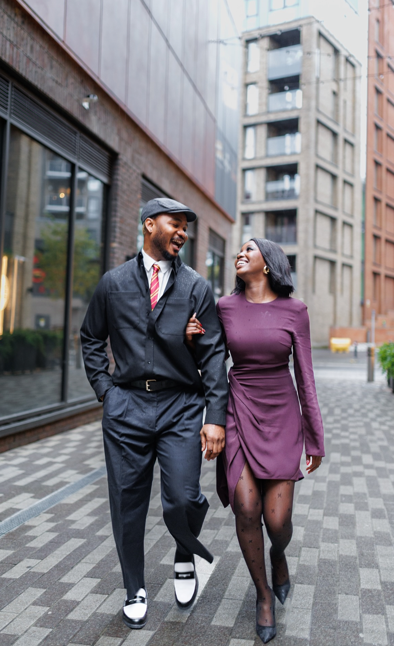 Couple embracing against a colourful street art backdrop in Digbeth during an urban industrial wedding in Birmingham.