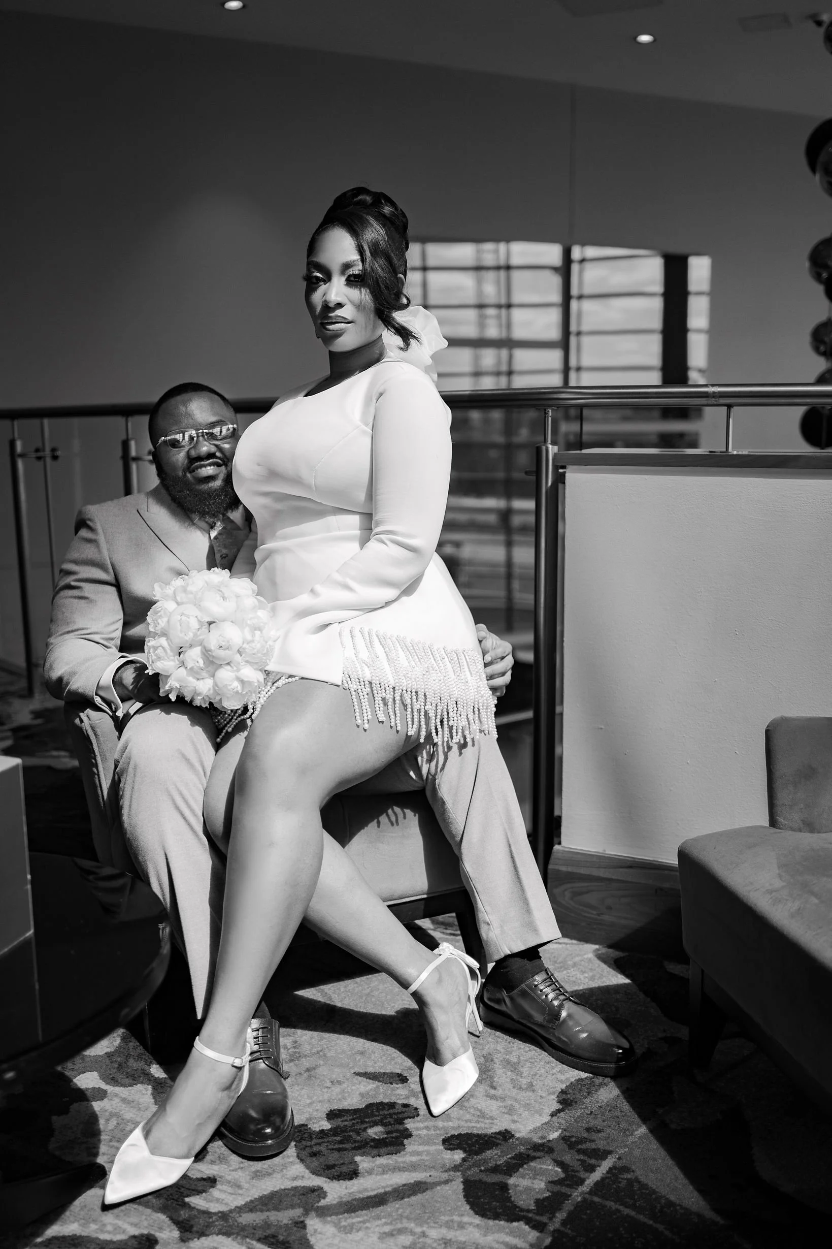 Newlywed couple enjoying cocktails inside a stylish Northern Quarter art gallery venue during a modern Manchester wedding.