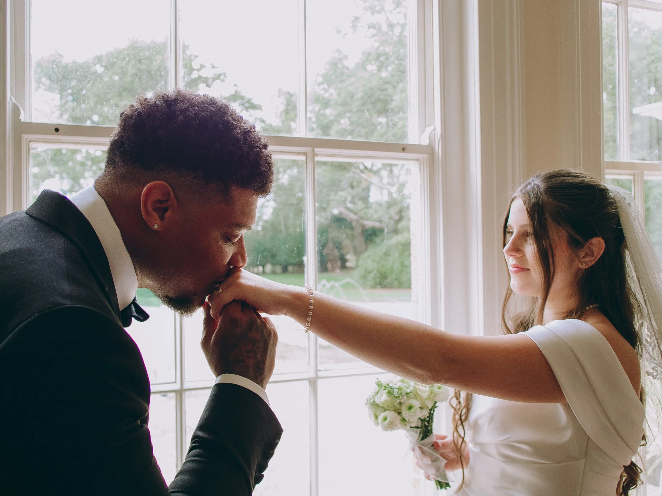 Bride and groom laughing together during an emotional documentary couple portrait session in London.