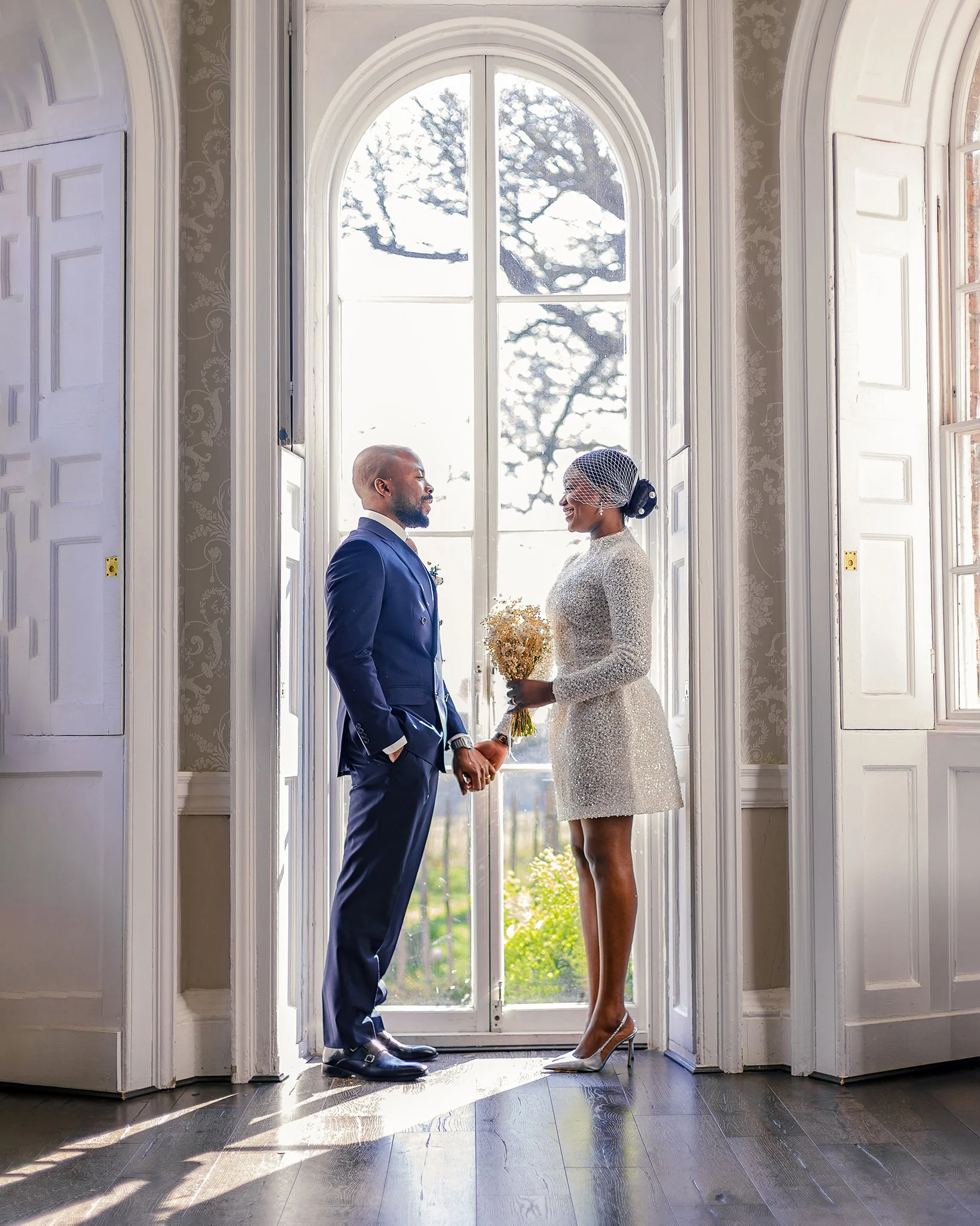Bride and groom exchanging rings during an intimate civil ceremony at Merton Register Office in South West London.