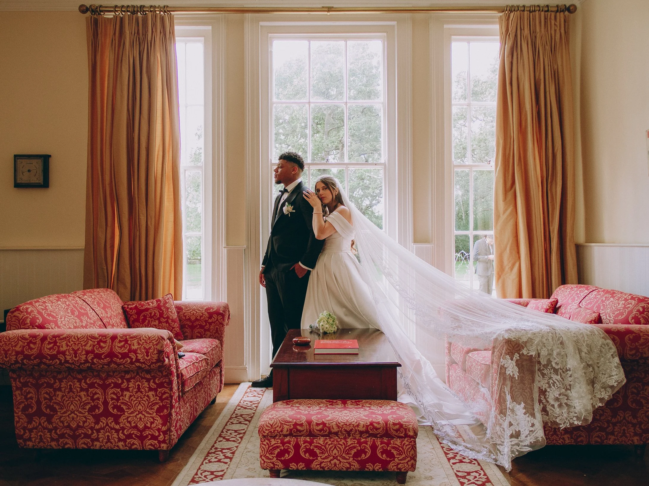Newlywed couple enjoying cocktails inside a stylish Northern Quarter art gallery venue during a modern Manchester wedding.