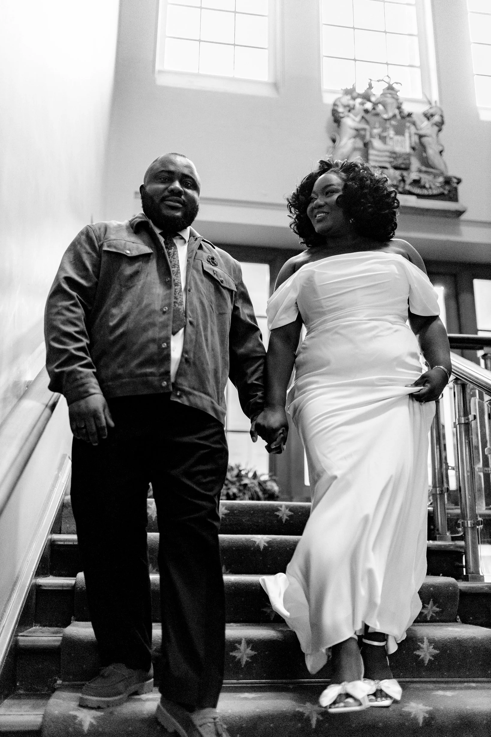 Bride and groom sharing an intimate moment on the stone staircase inside The Old Council House Bristol.