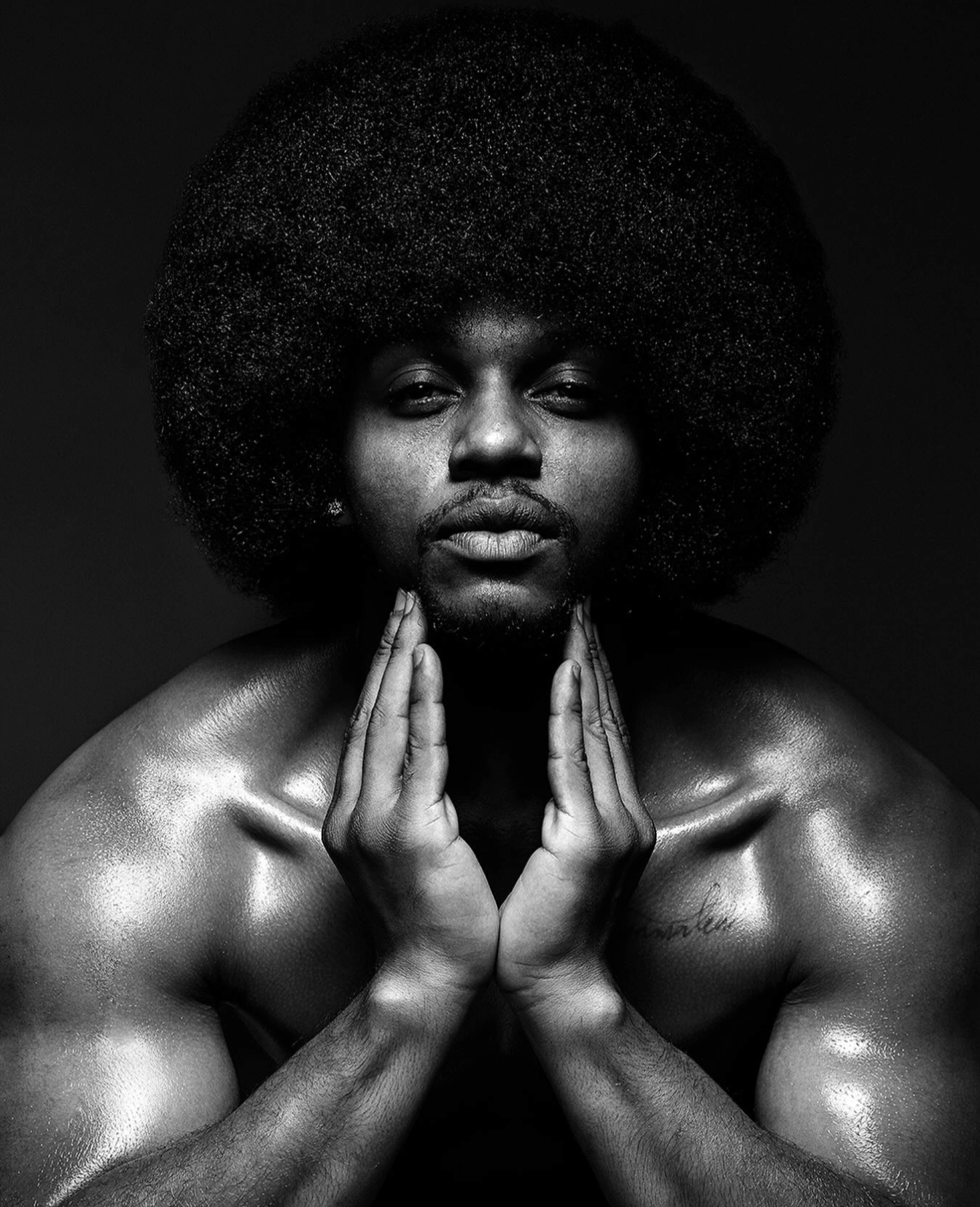 Male model posing for a men's grooming and skincare brand campaign in a contemporary London studio.