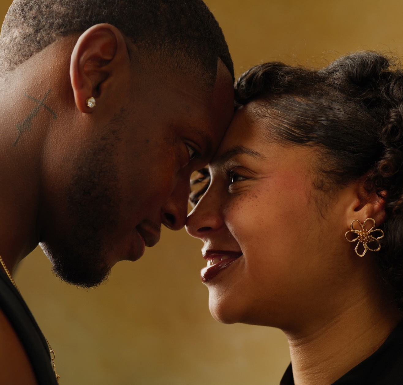 Newlywed couple embracing closely and looking intensely into each other's eyes during an intimate wedding session in London.