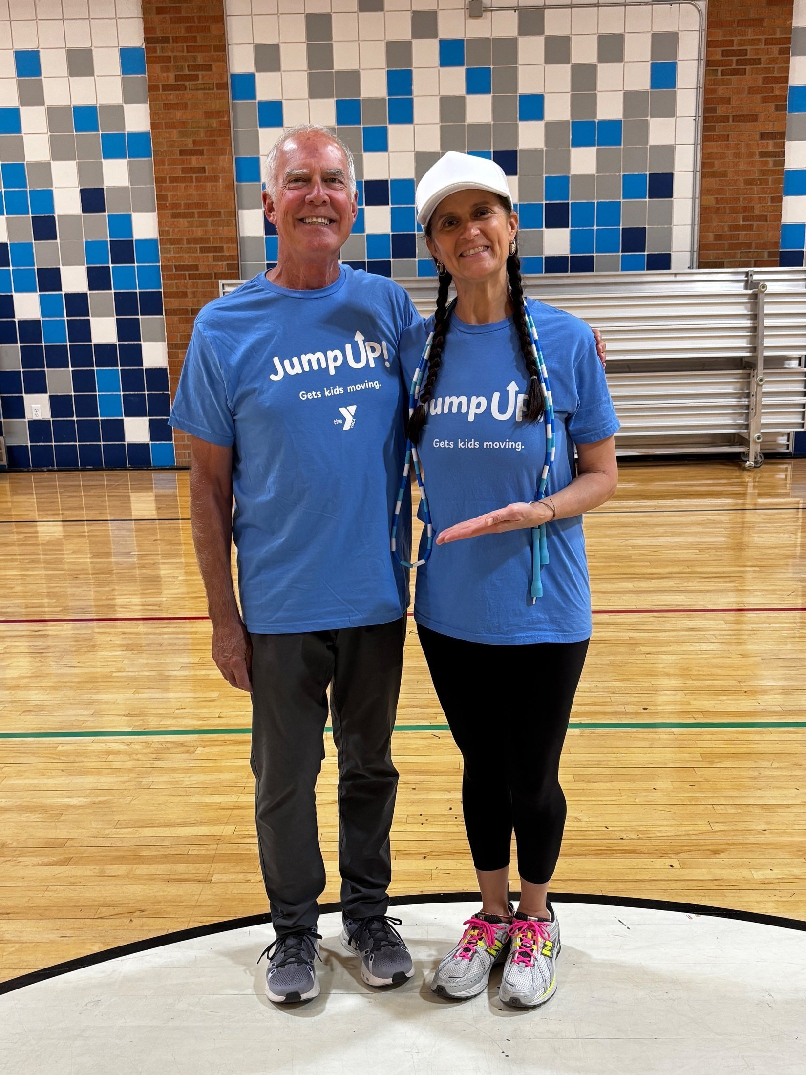 Donor Mitch Pelsue and Jump UP! founder Cher in matching Jump UP! t-shirts in a YMCA gym